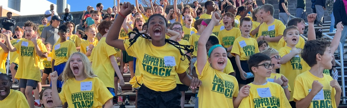 Photo of elementary students cheering at a track meet