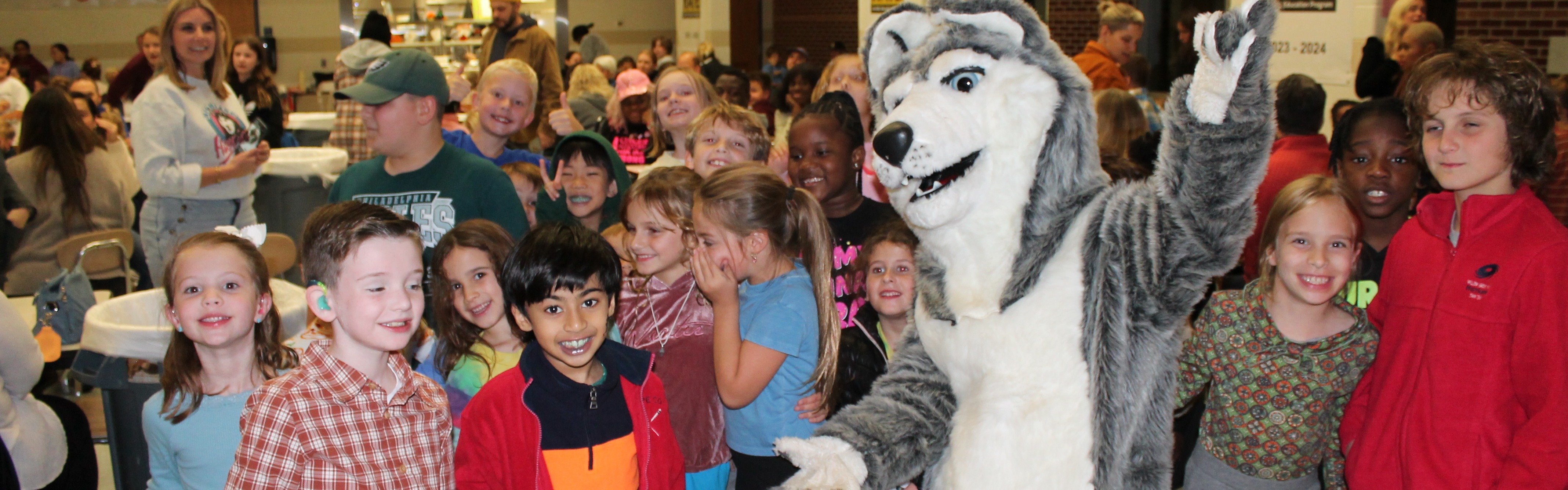 Students gathered around the Highland Husky Mascot