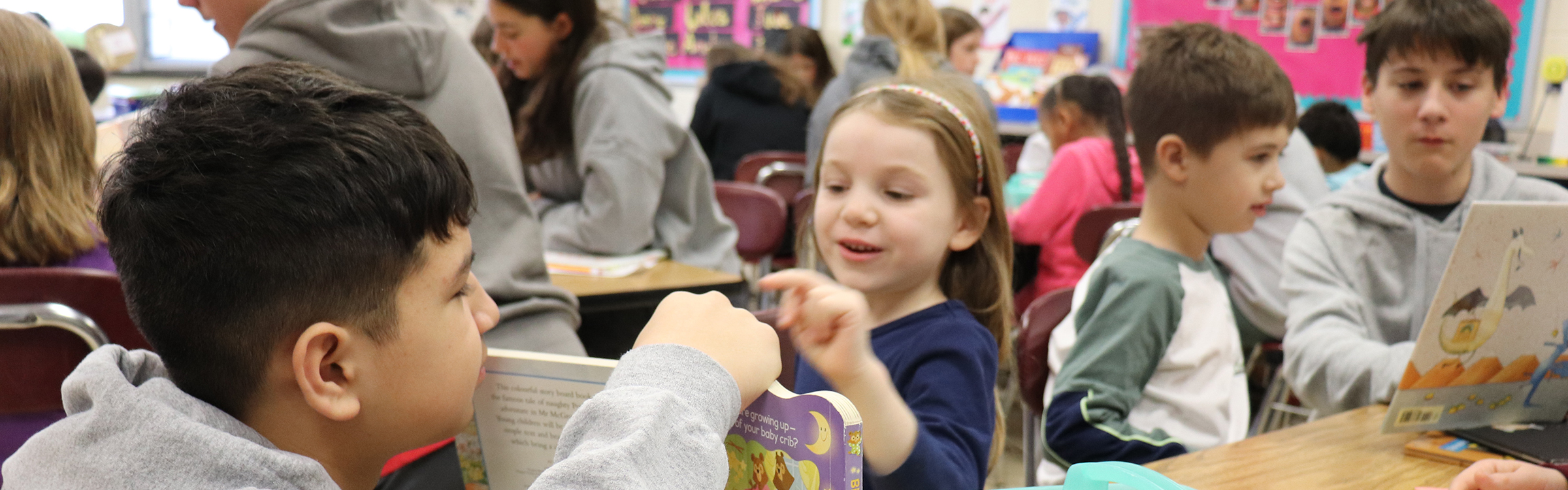 Abington Middle School mentors read to students at Overlook Elementary School.