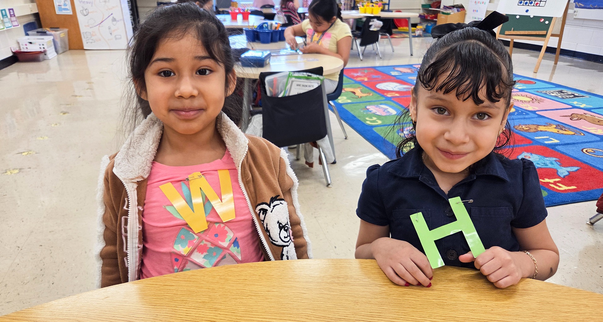 two students smile for the camera