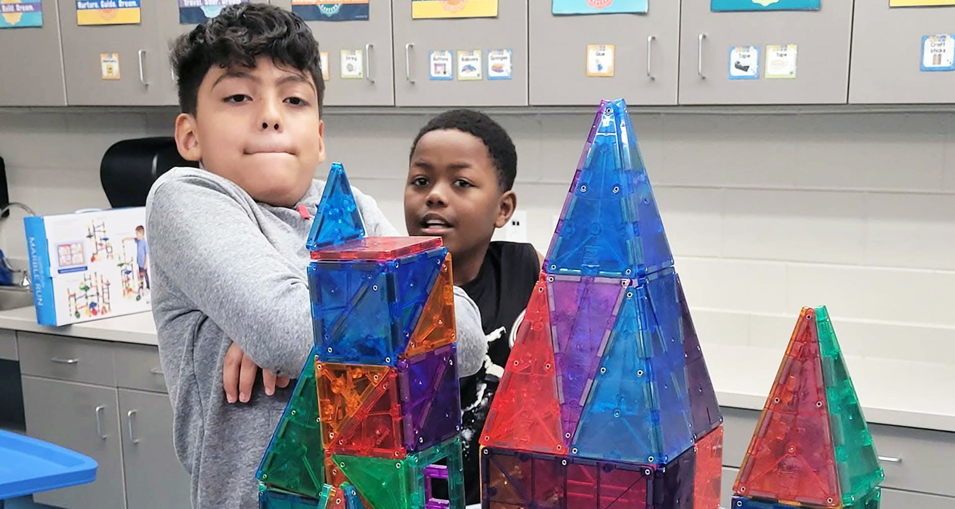 Two students show off their block building