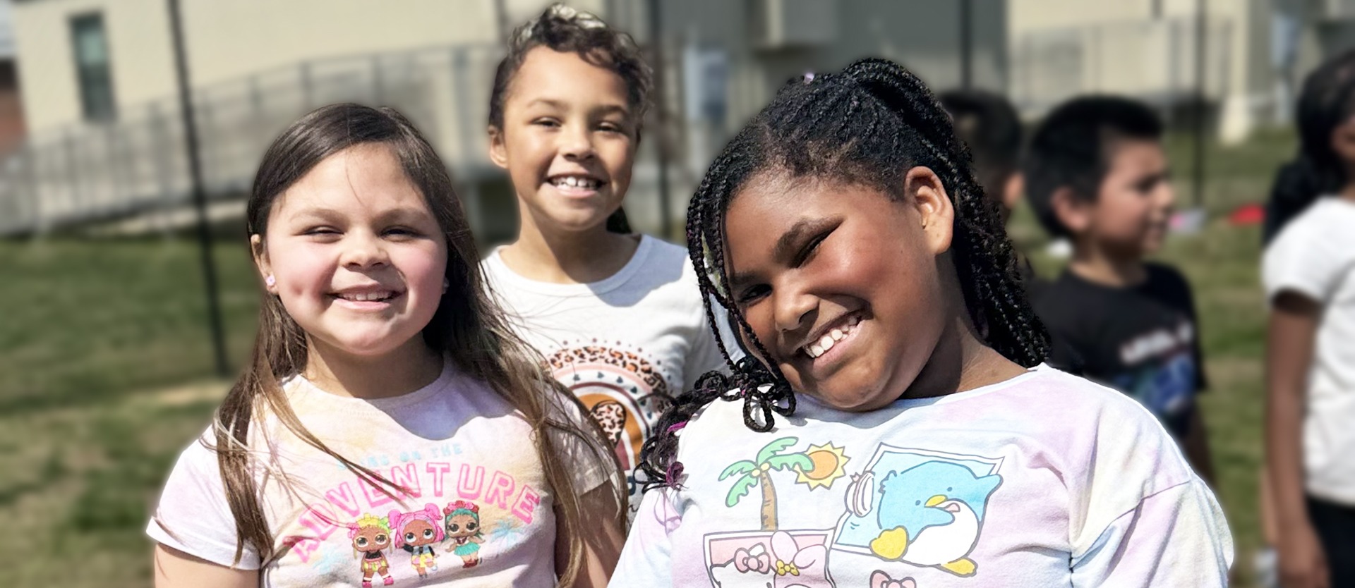 three students smile for the camera