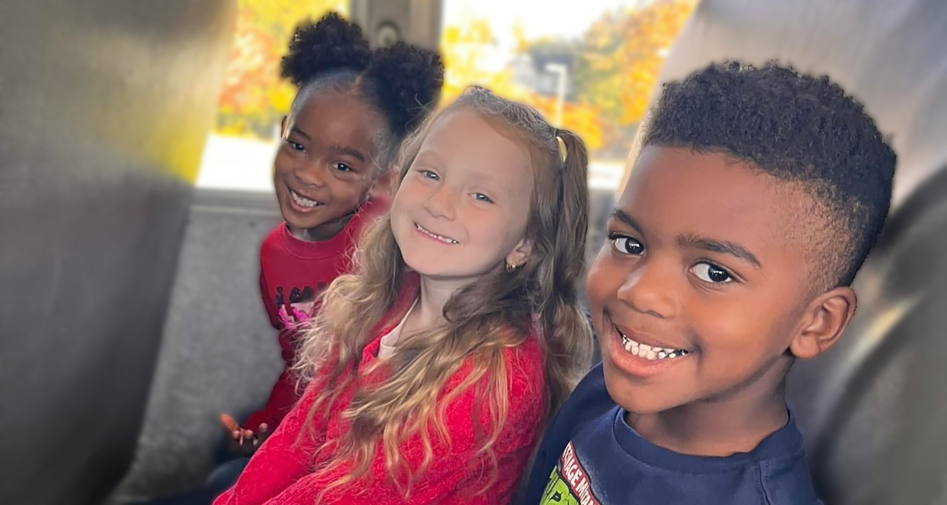 three students smile for the camera