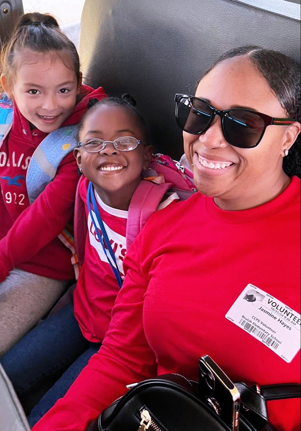students ride on bus with a volunteer