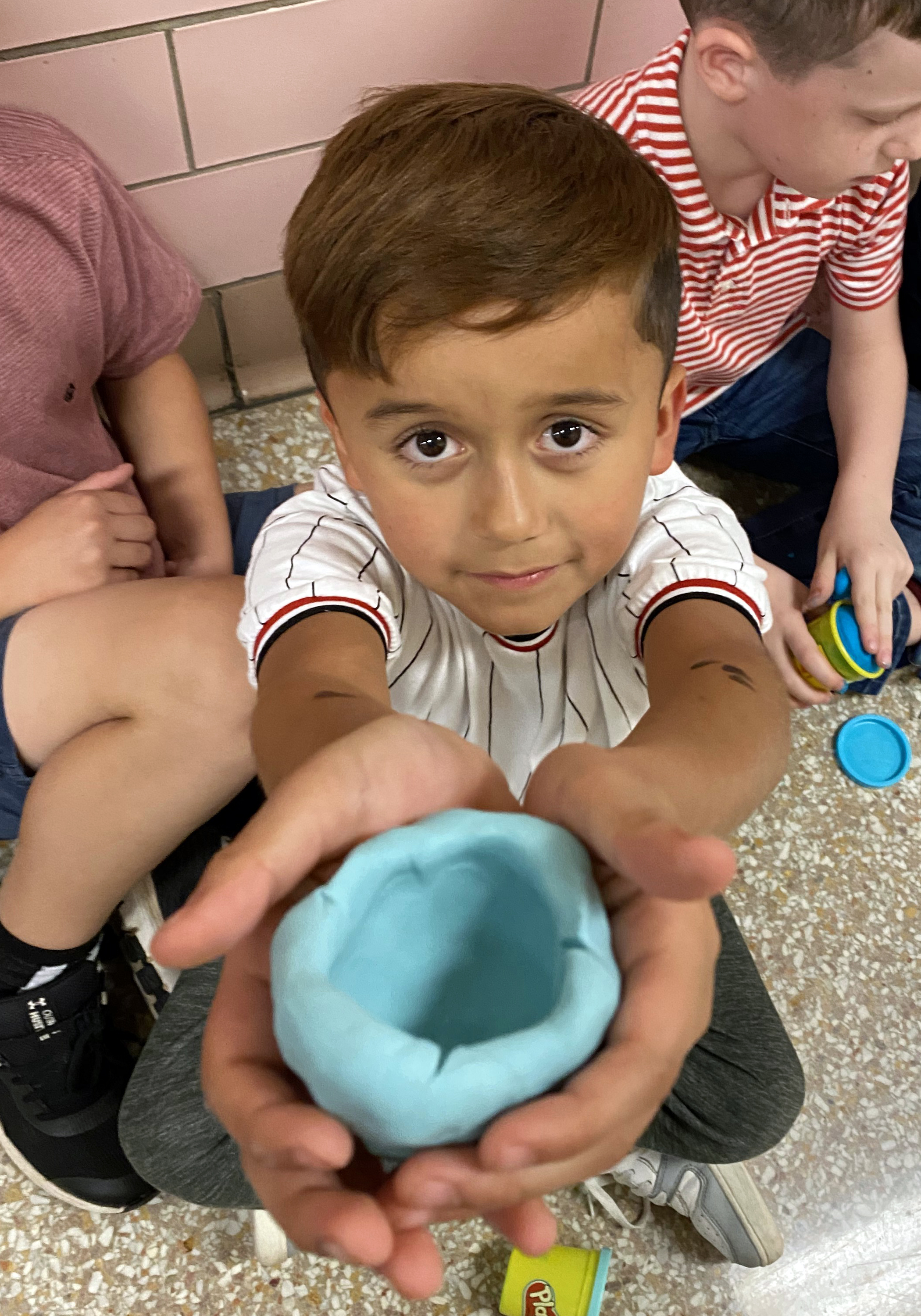 Student holding Play-Doh