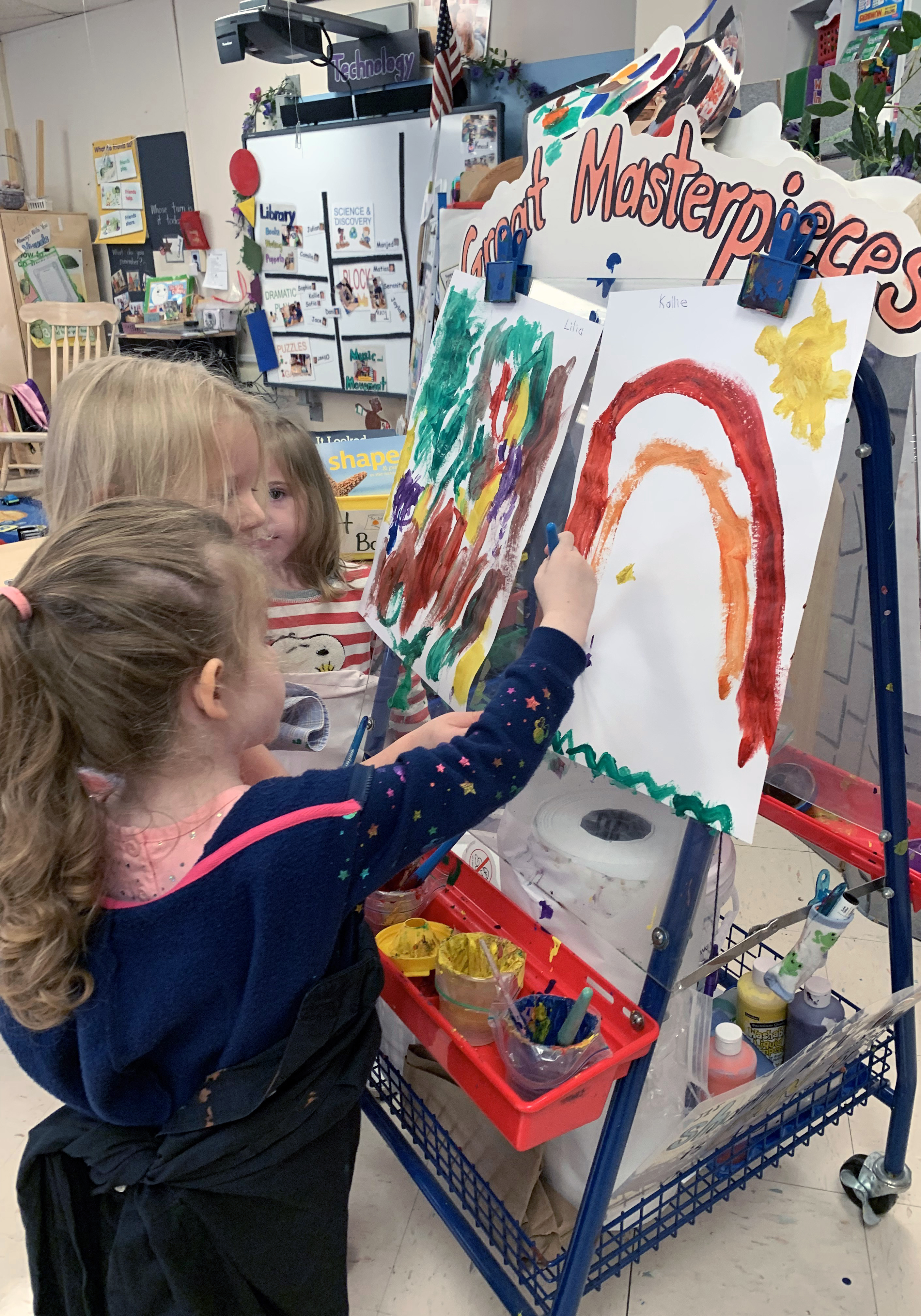 Three students painting with water color