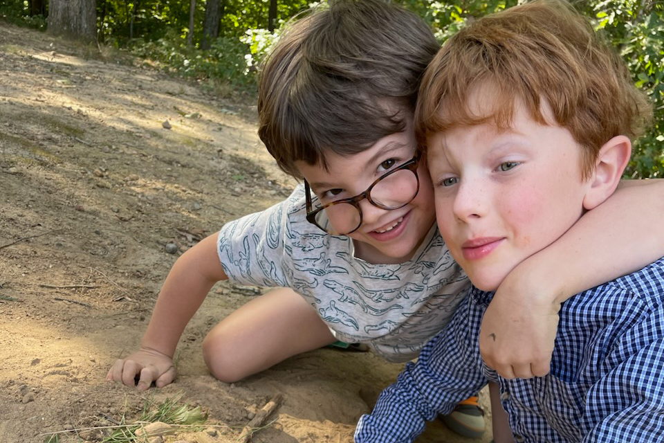 A student hugging another student