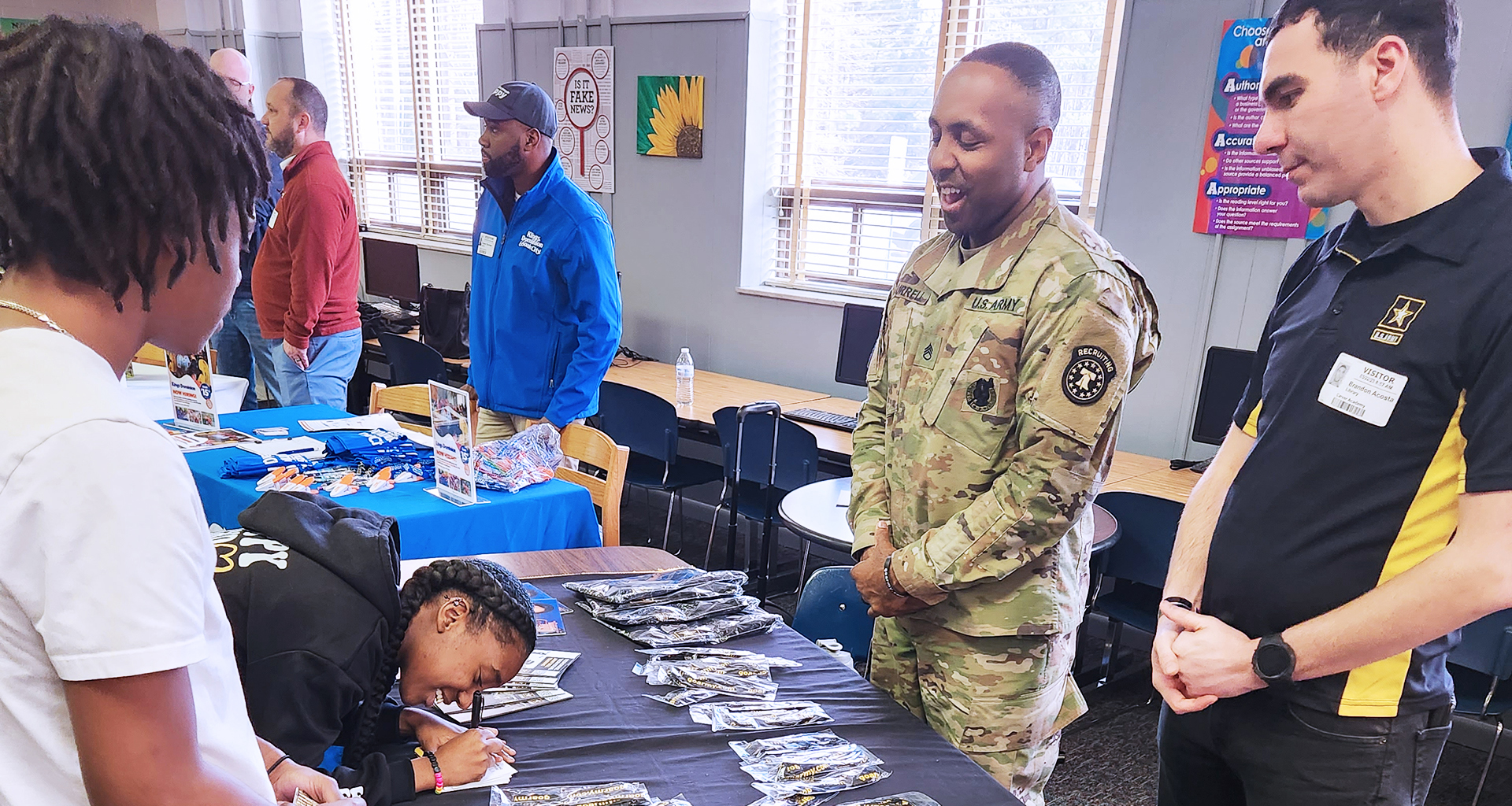 Students speaking to military at a job fair