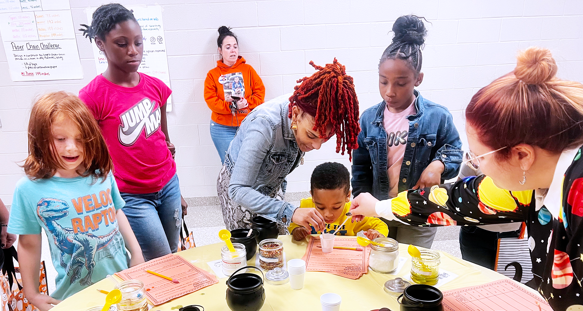 A volunteer helping students with a class project