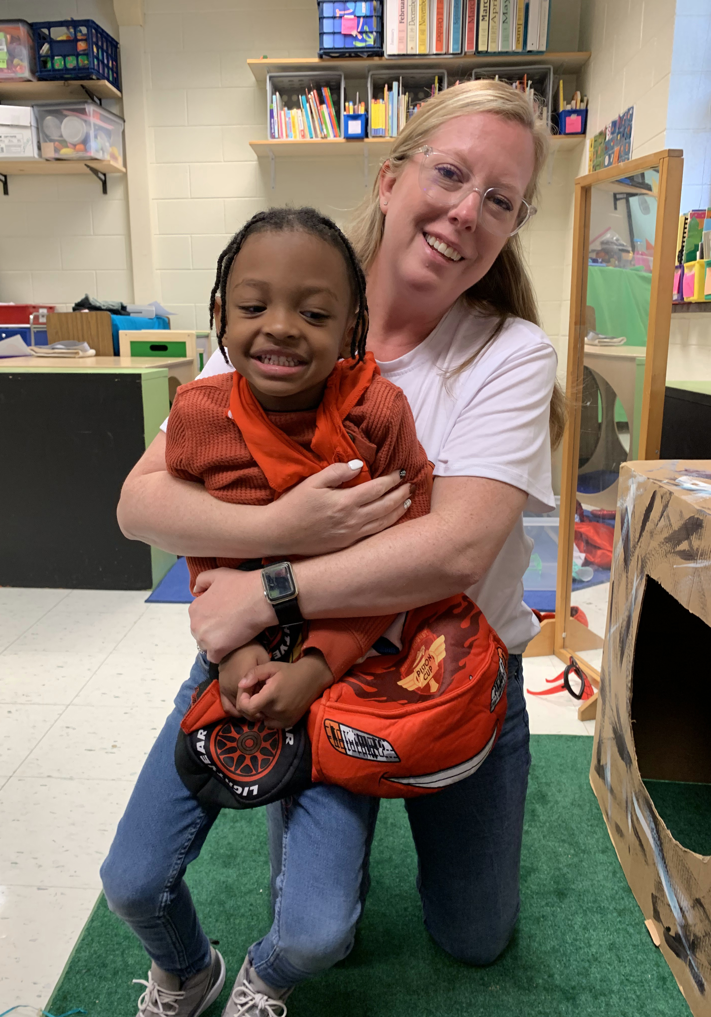 A teacher hugging a student