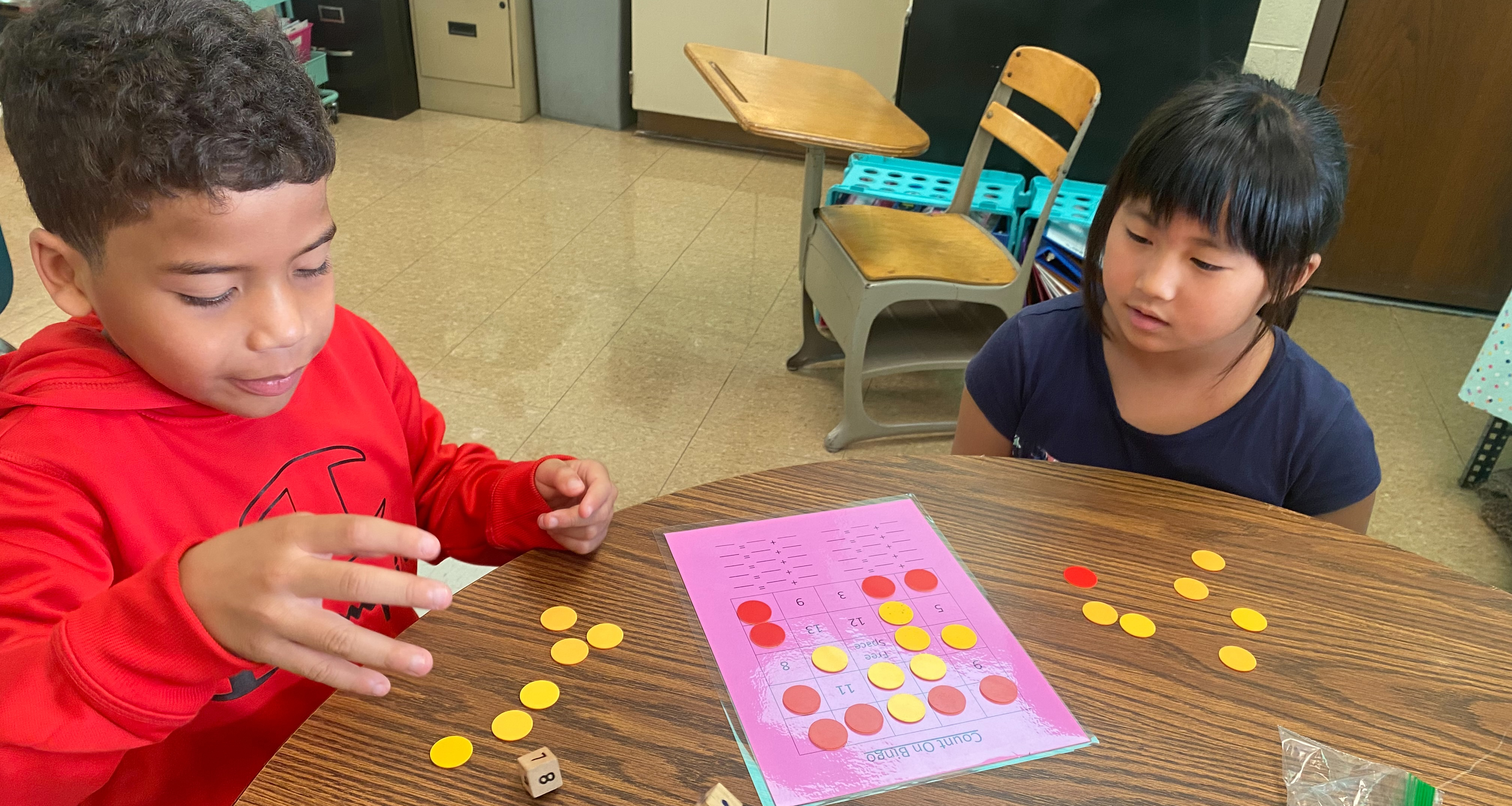 Two students playing bingo in class