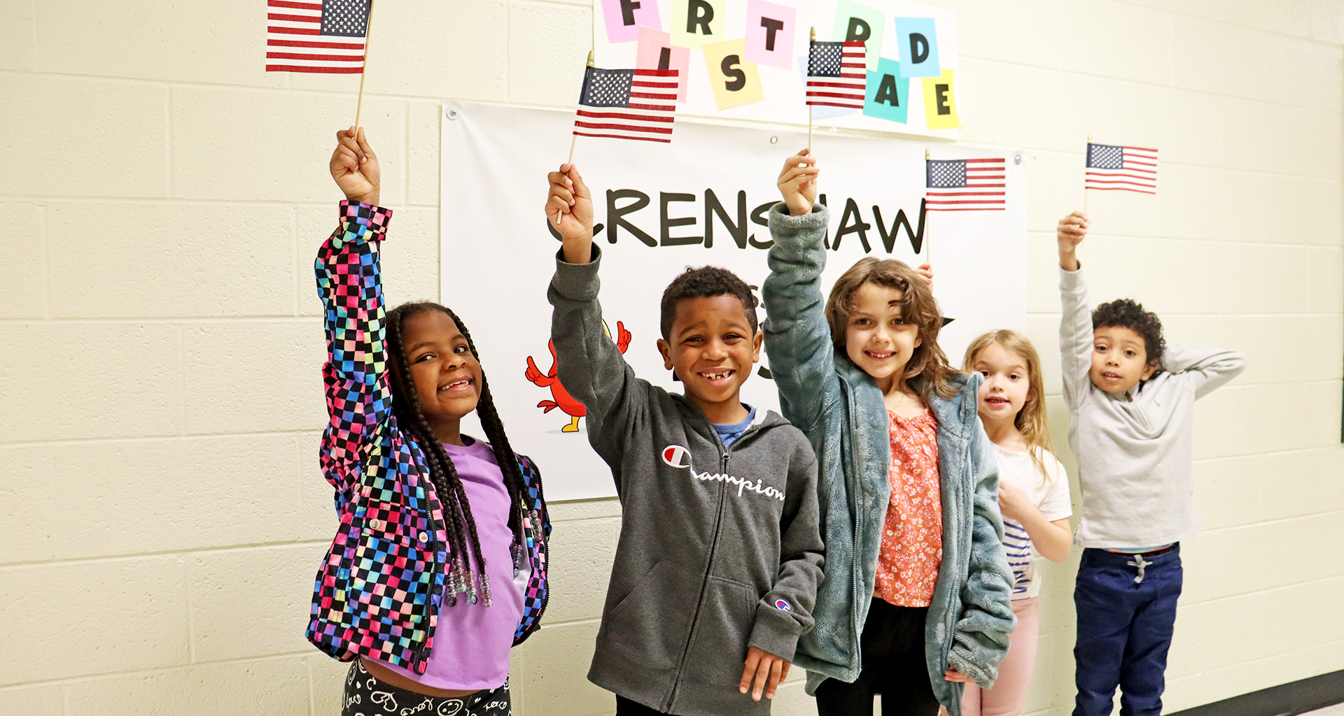 Five students holding up american flags.