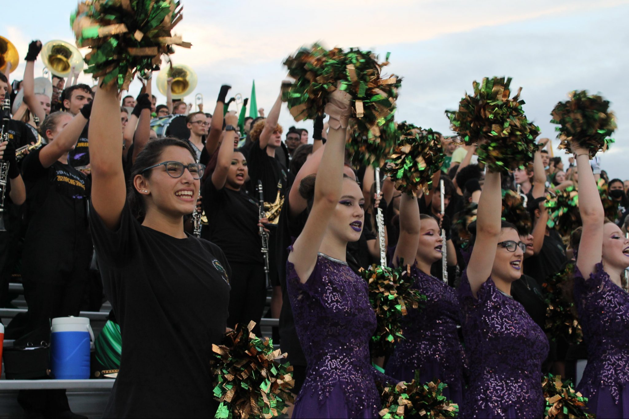 Students celebrating on the bleachers during a football game