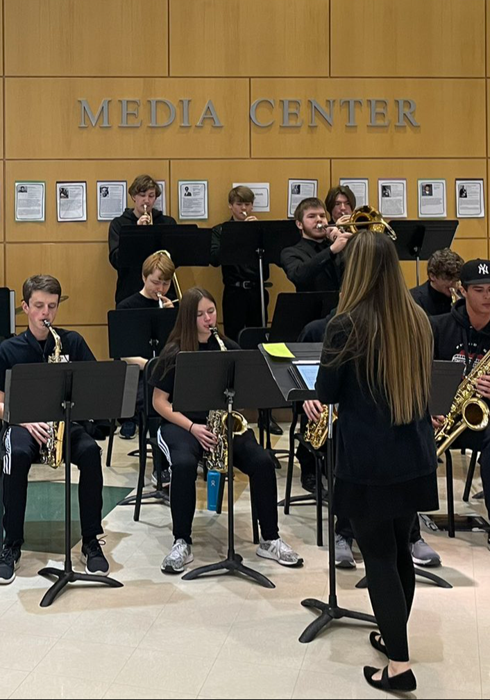 A group of students playing their instruments during a performance