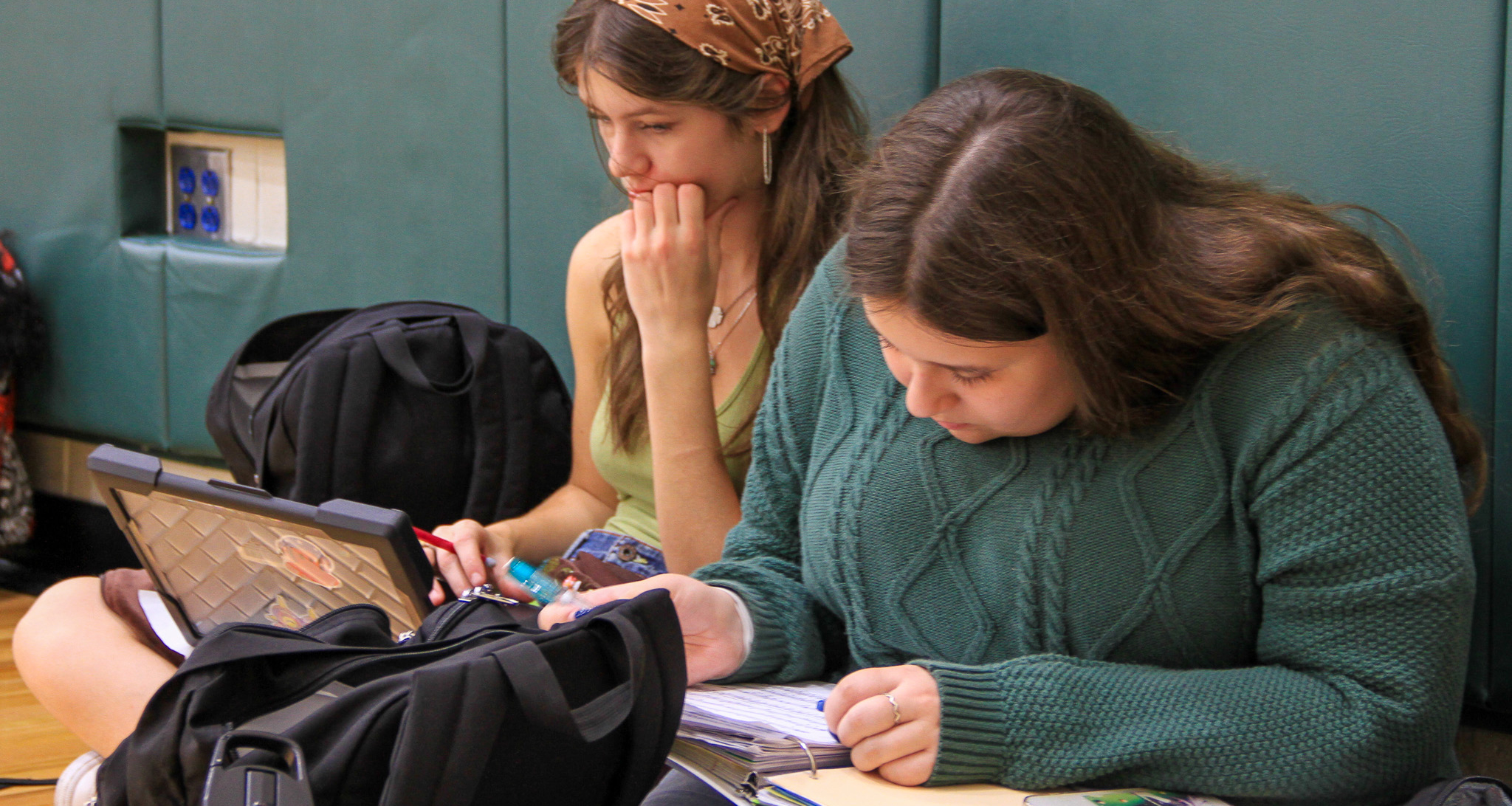 Two girls studying in the school gymnasium
