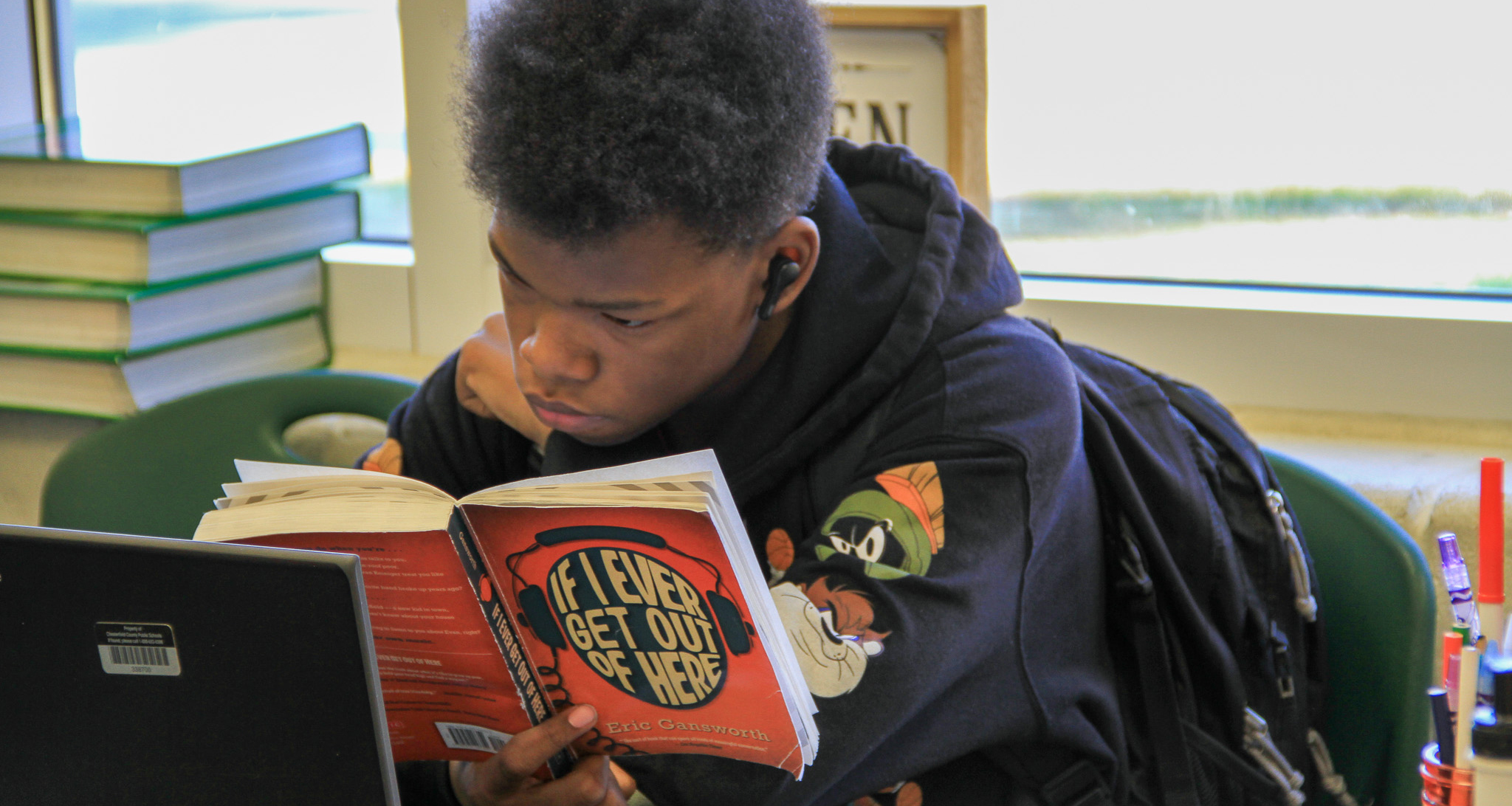A student reading a book in class
