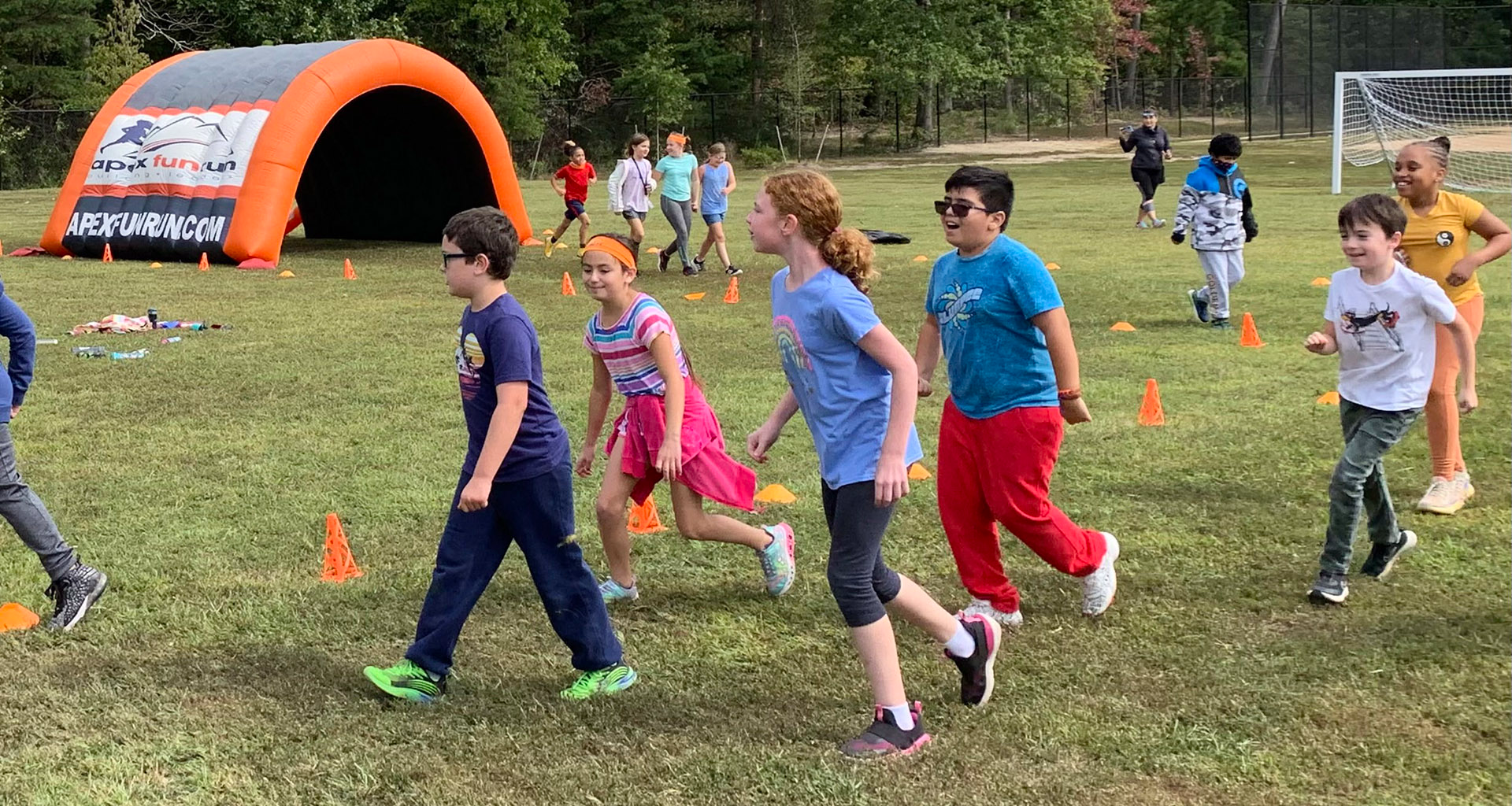 Students running outside during field day.