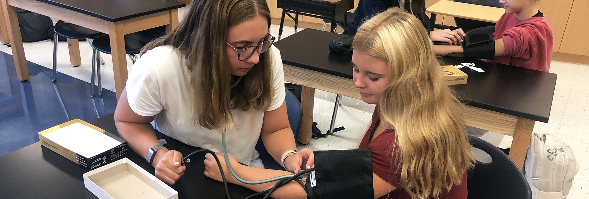 student taking pulse of other student