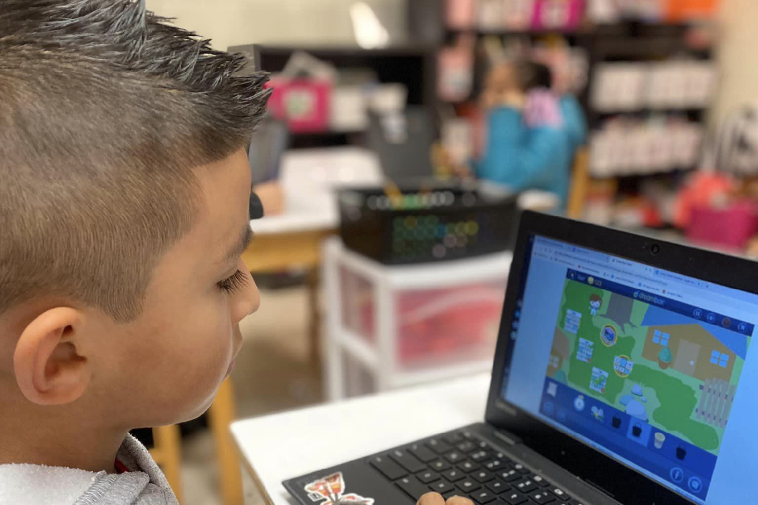 kid looking at a computer