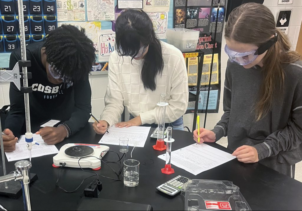 Three students working on a science project