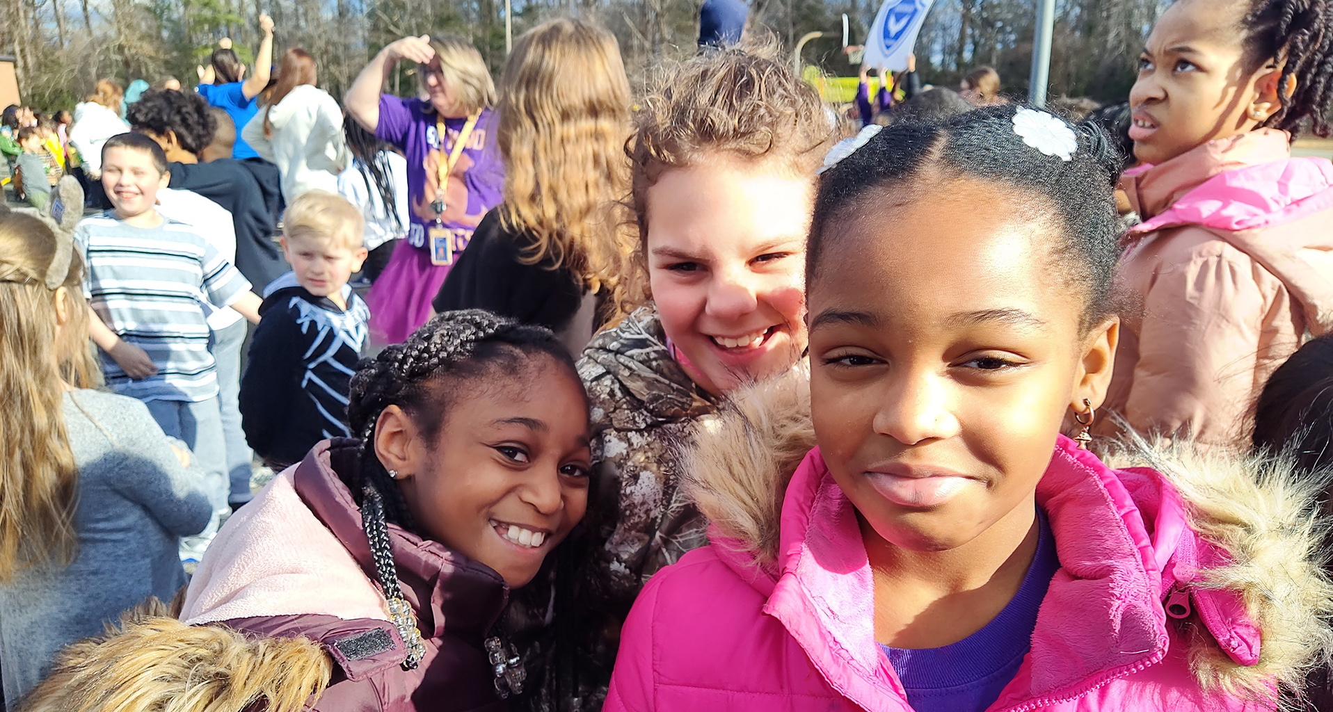 Students outside a small group pose for a photo