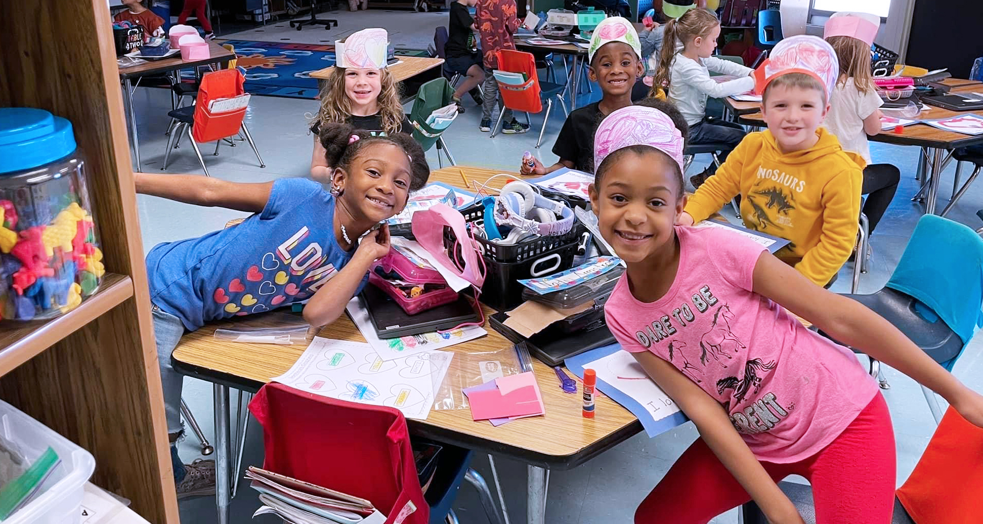 Classroom photo. Several students smile for the camera.