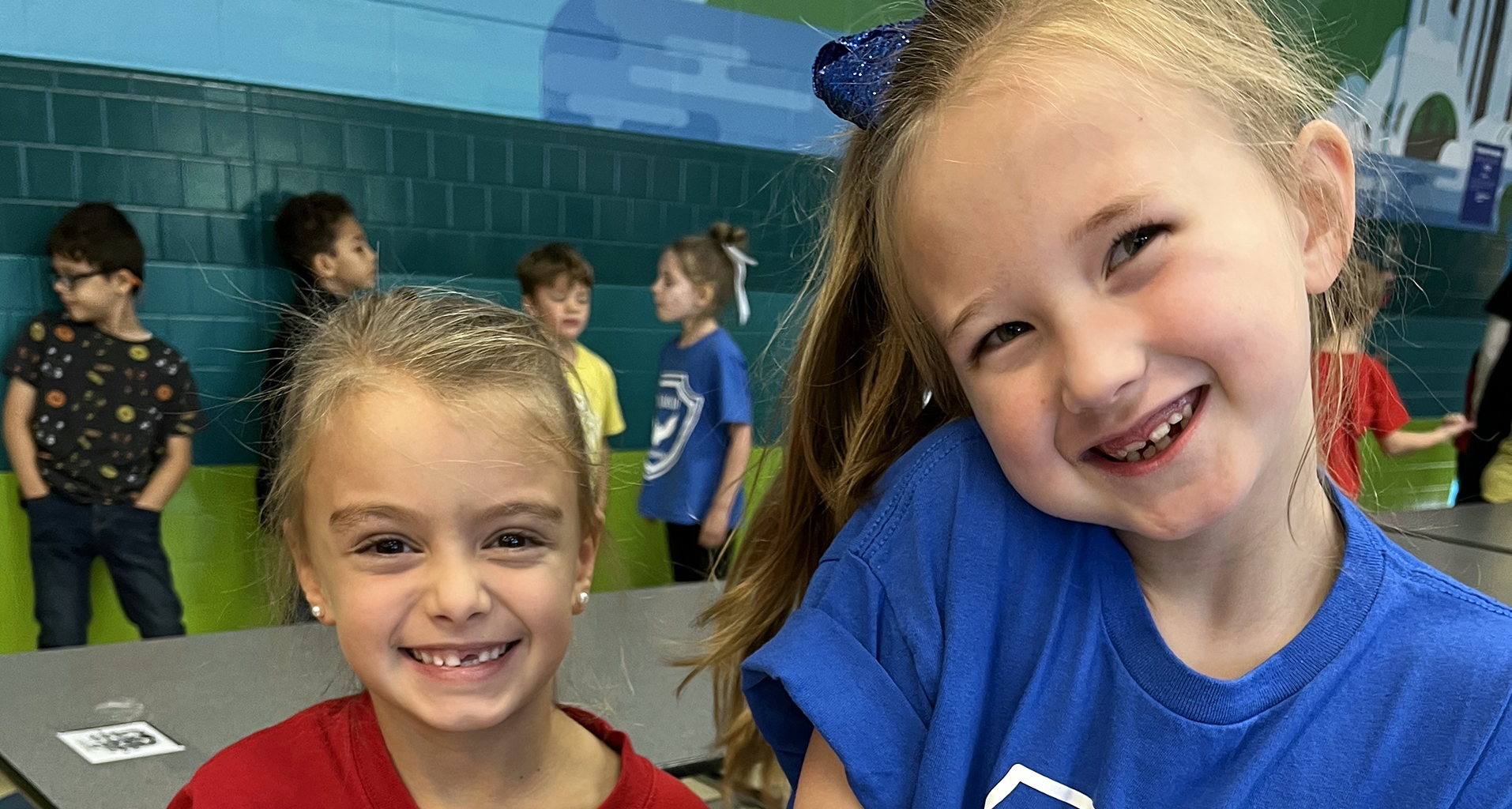 Two female students smile for the camera