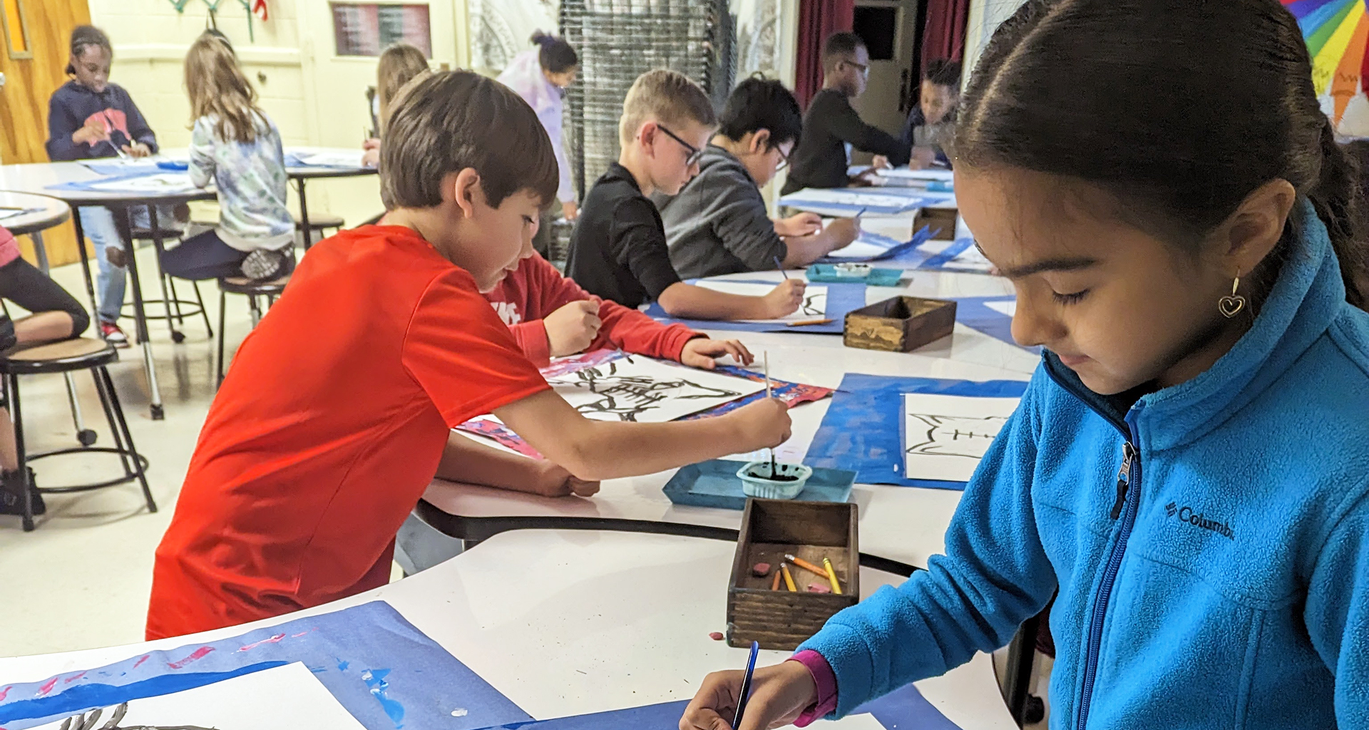 Students painting in art room