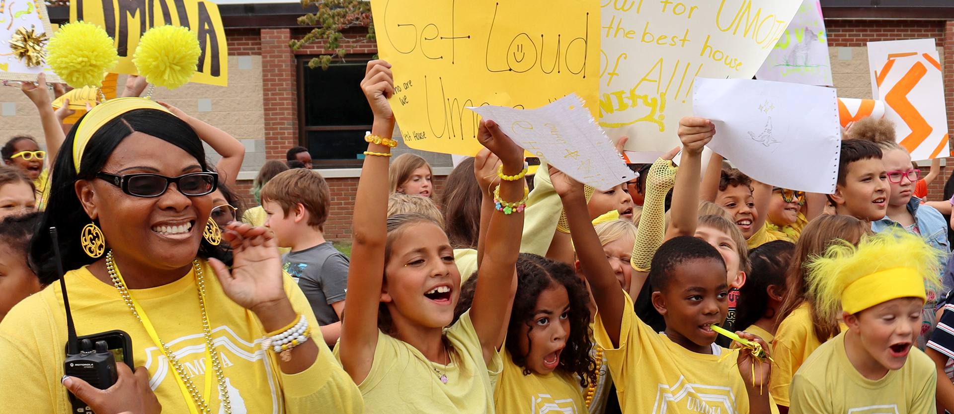 Students with teacher during house ceremony. All dressed in yellow.