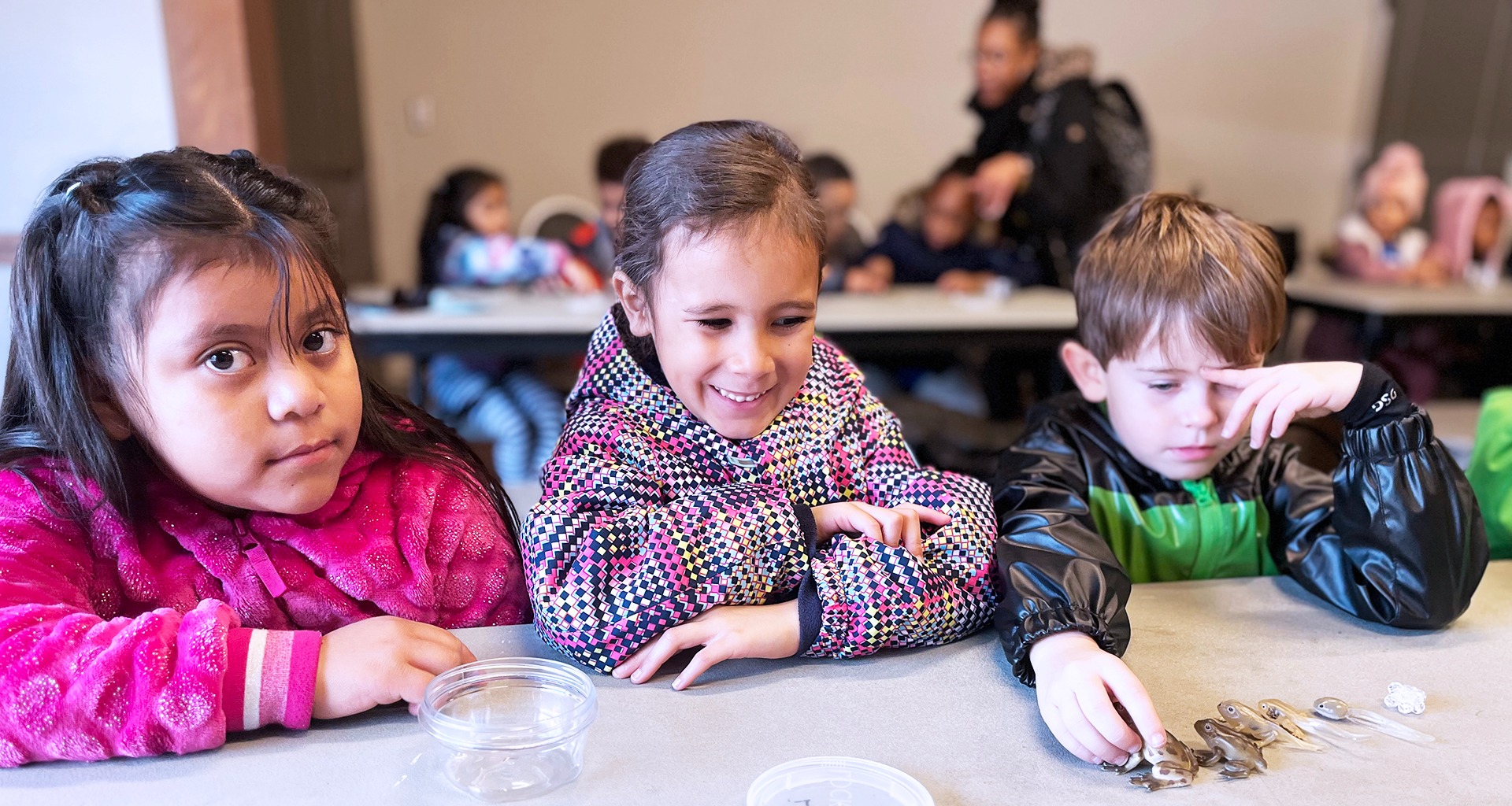 three students sitting at a table