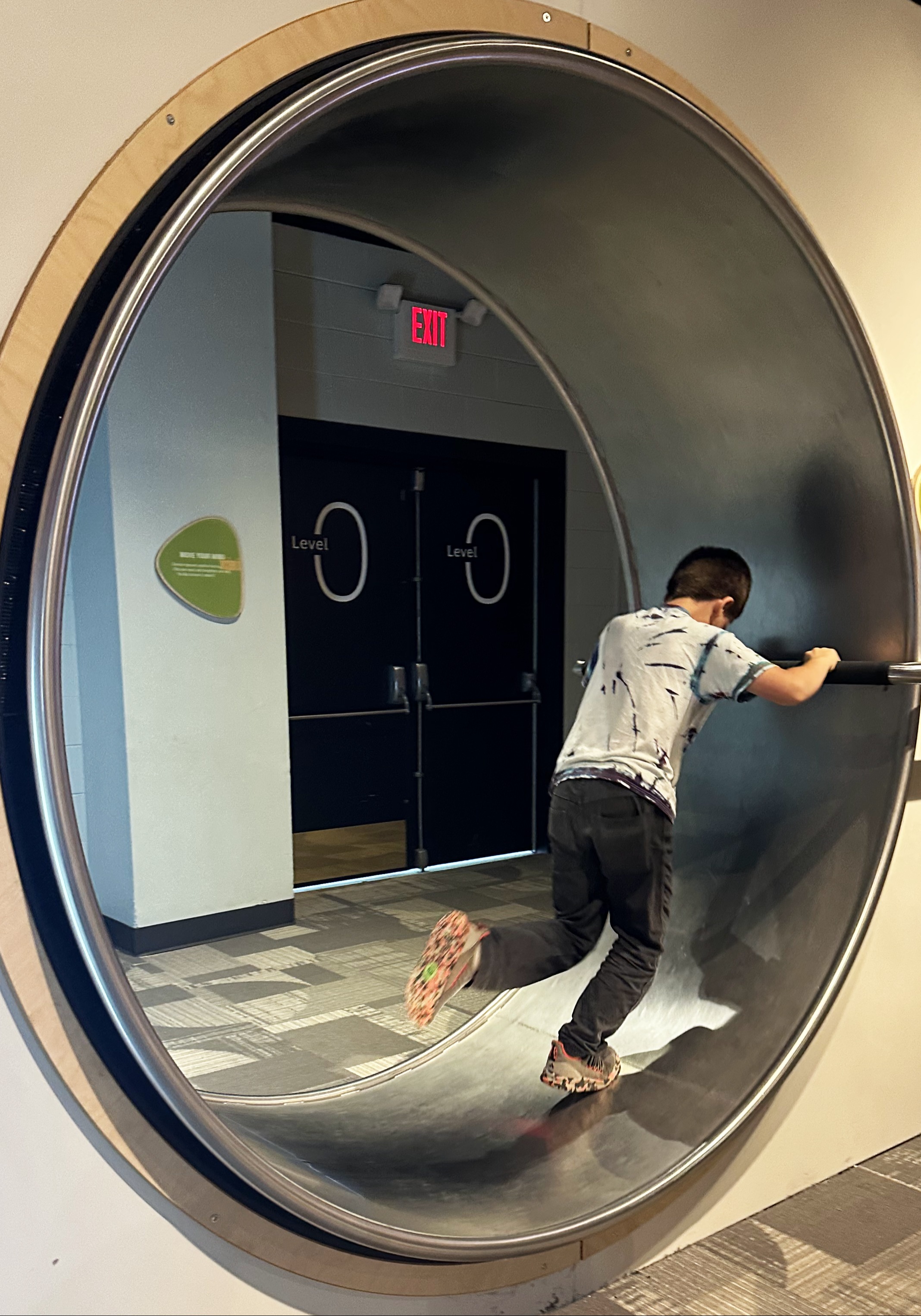 A student running in a giant spinning wheel