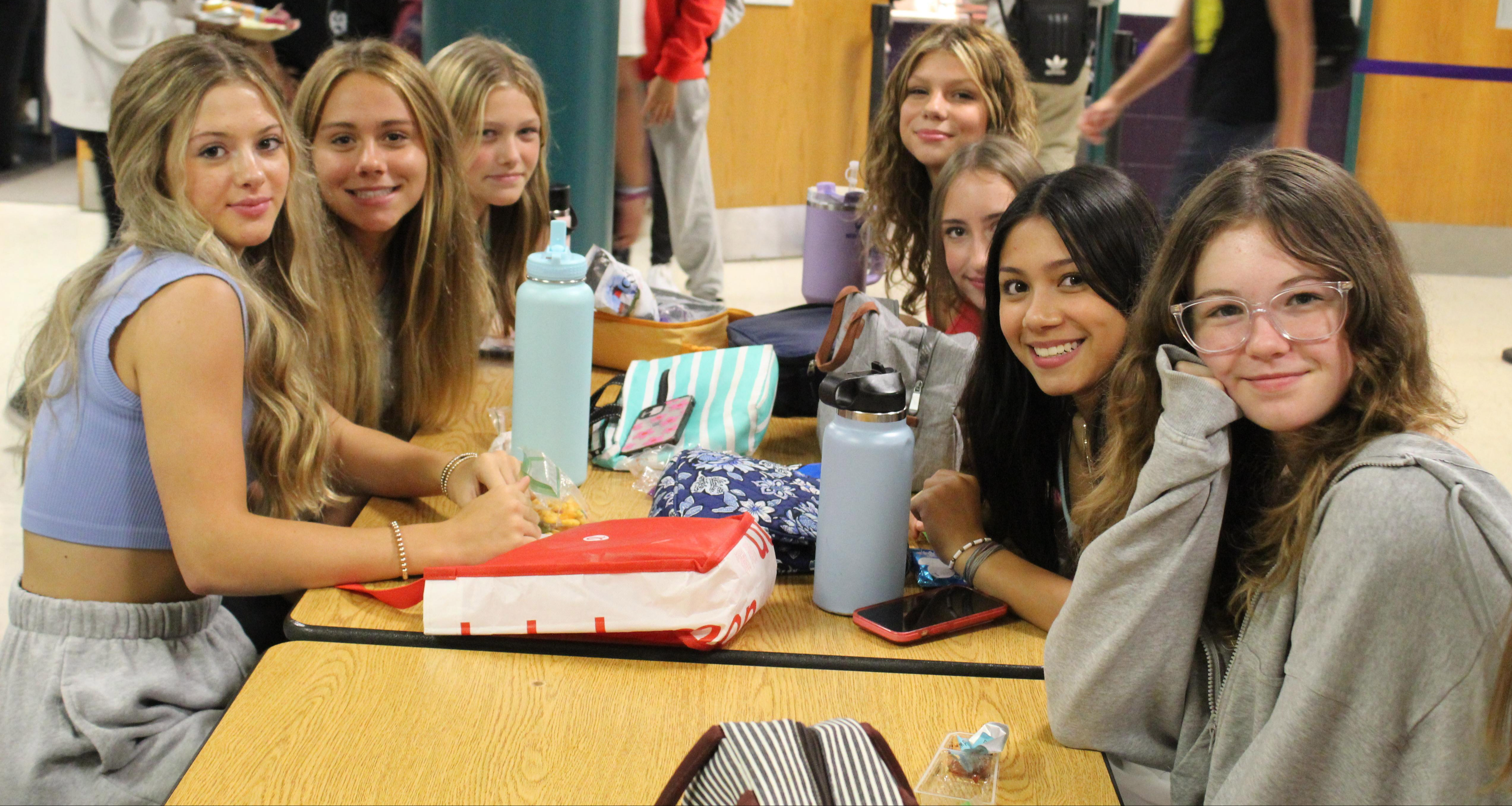 A group of girls eating at the school cafeteria