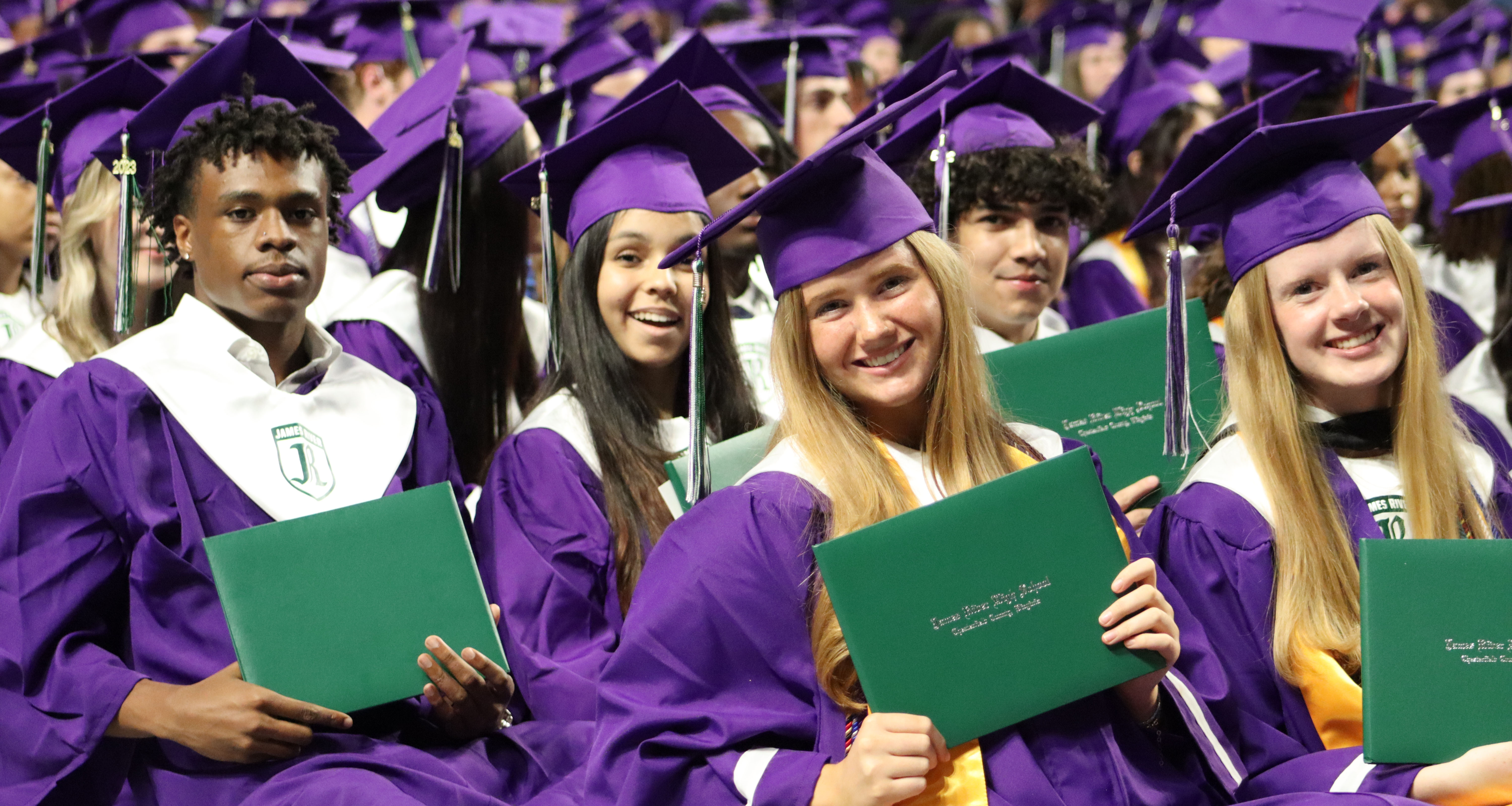 Seniors holding their diploma during a graduation ceremony