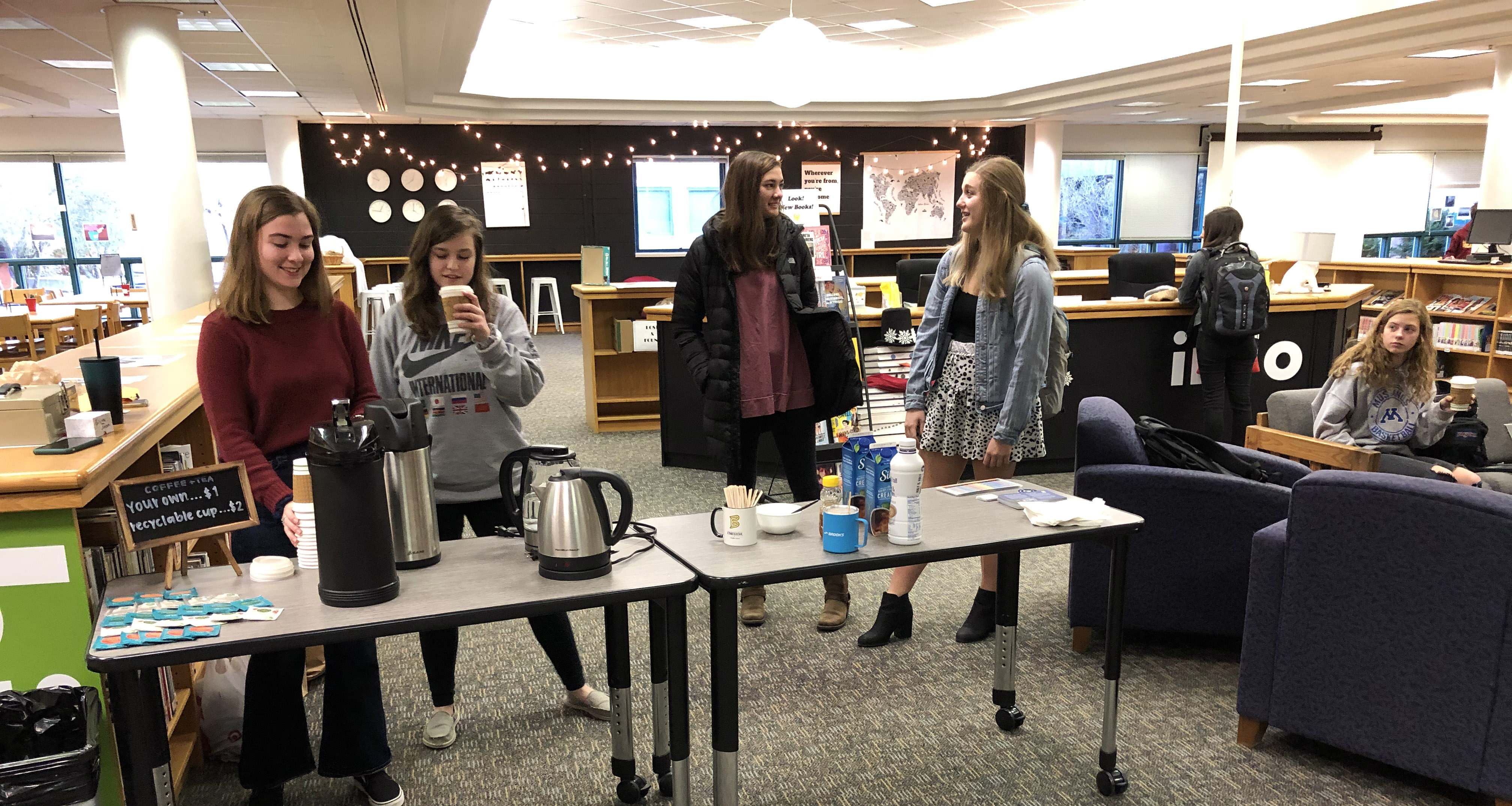 Students selling coffee in the school library