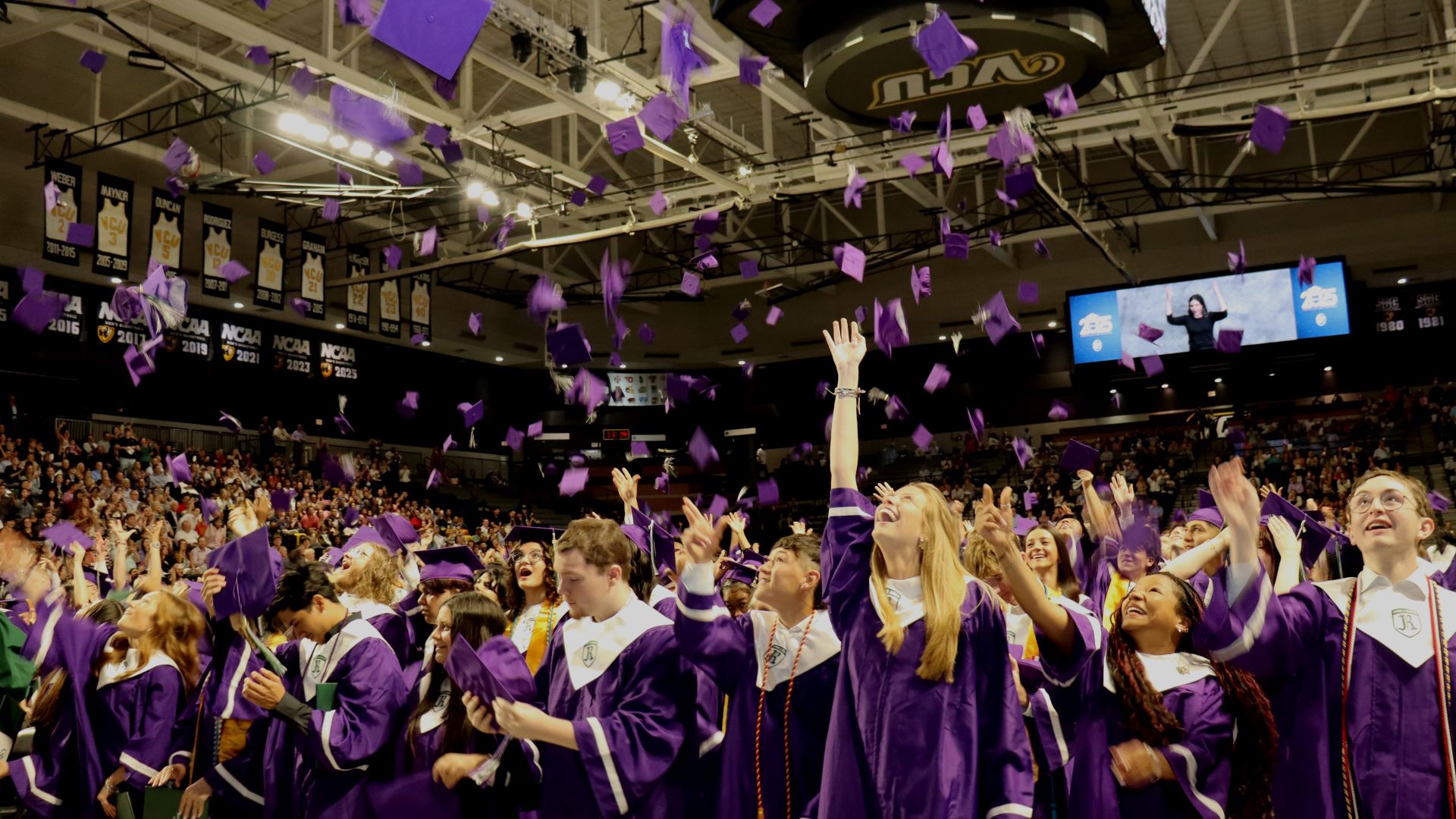 Graduates throwing their caps