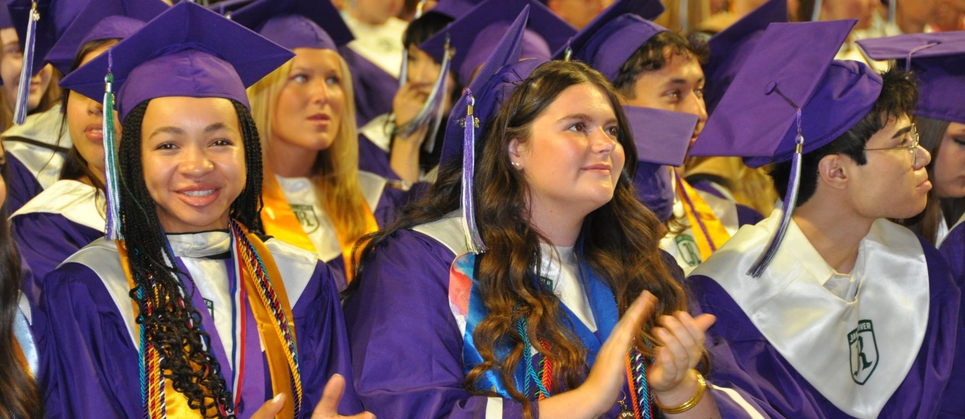 Graduates applauding and smiling