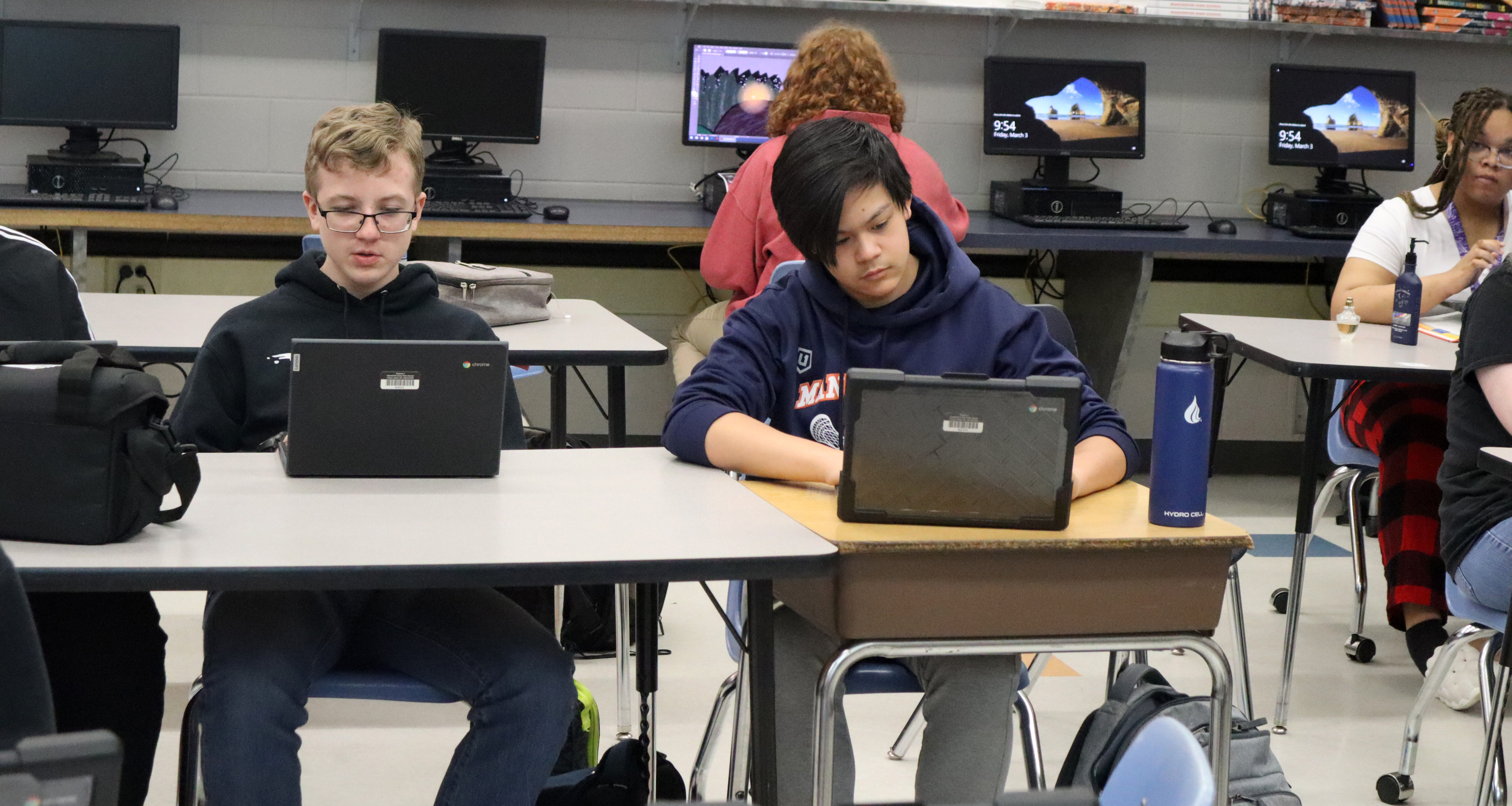 Students working on their laptops in class