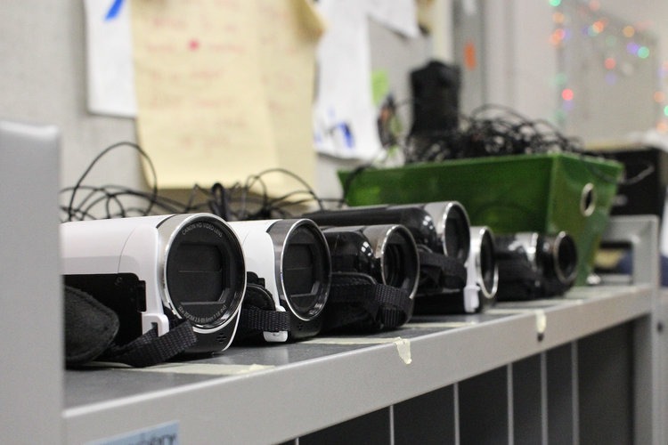Shelf with video cameras on it