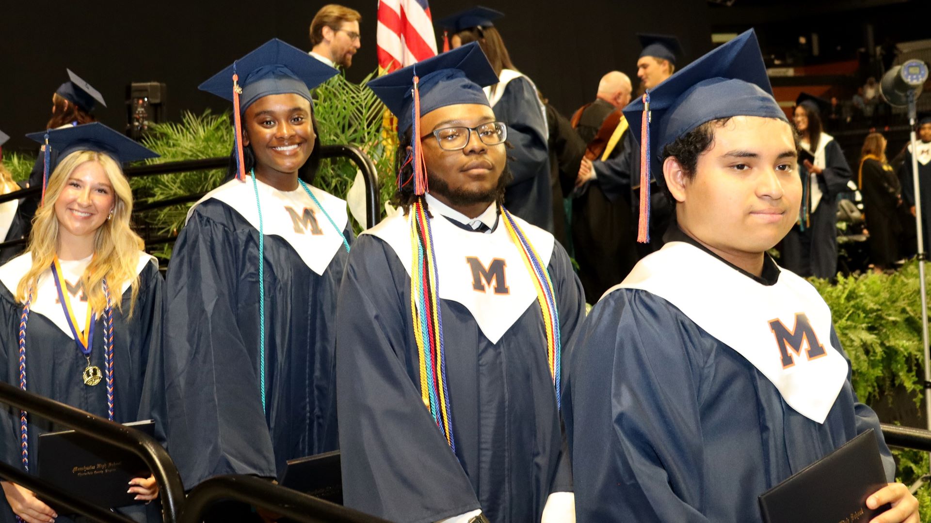 Graduates standing and smiling