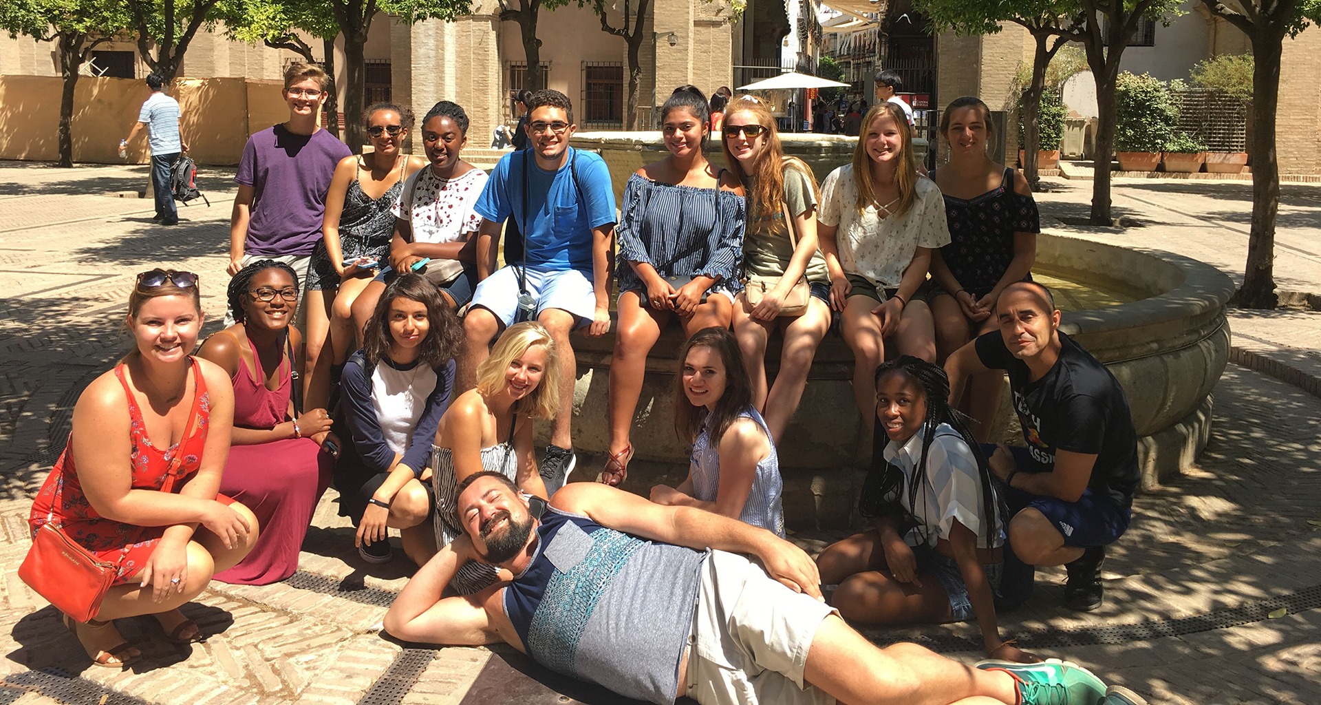 A group of students posing for a photo at a volunteer site