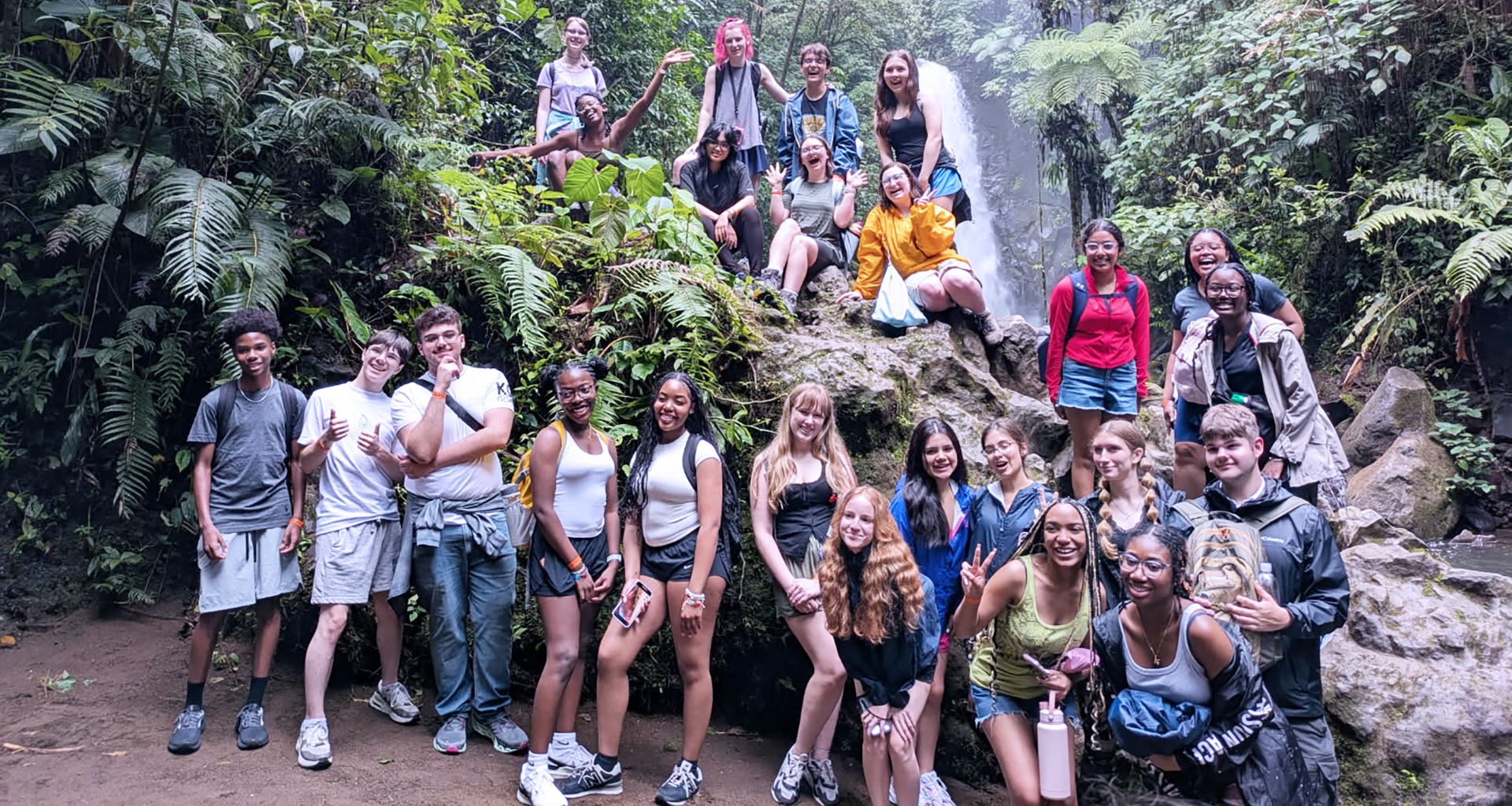 A group of students posing for a photo at a volunteer site