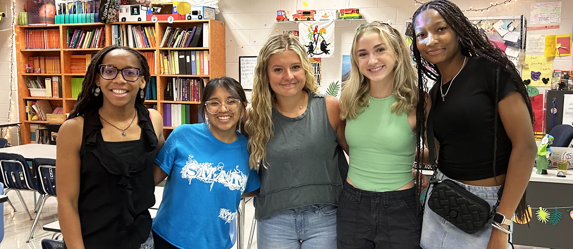Five students pose for a photo