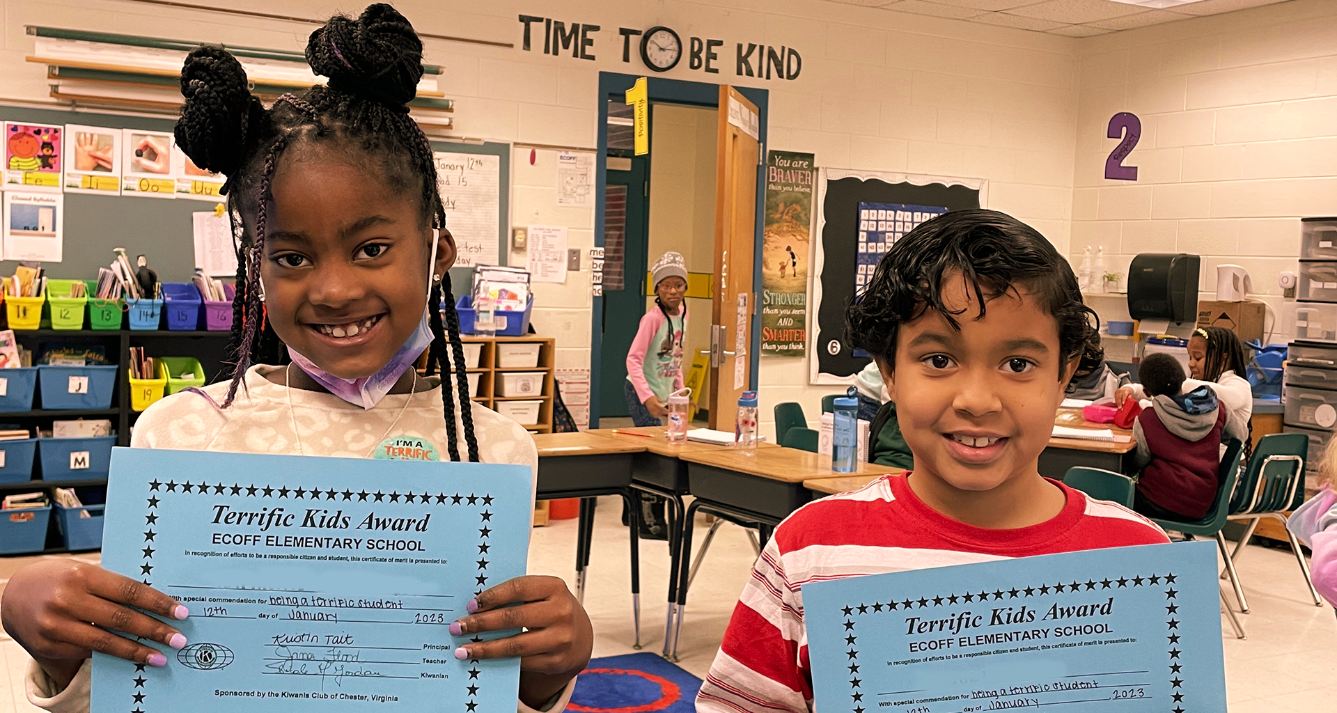 Two students showing their terrific kids award