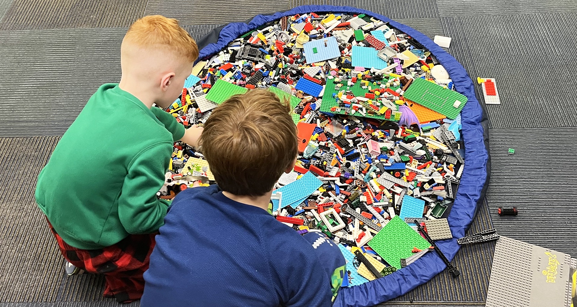Two students playing with legos