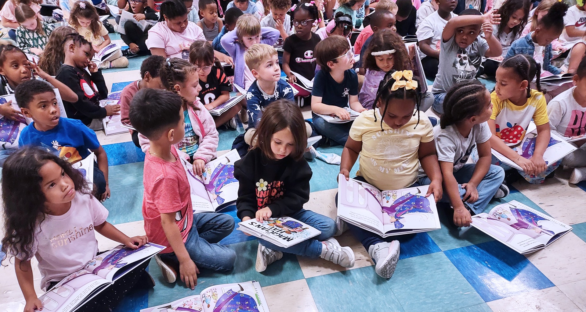Kids sitting on the floor reading books.