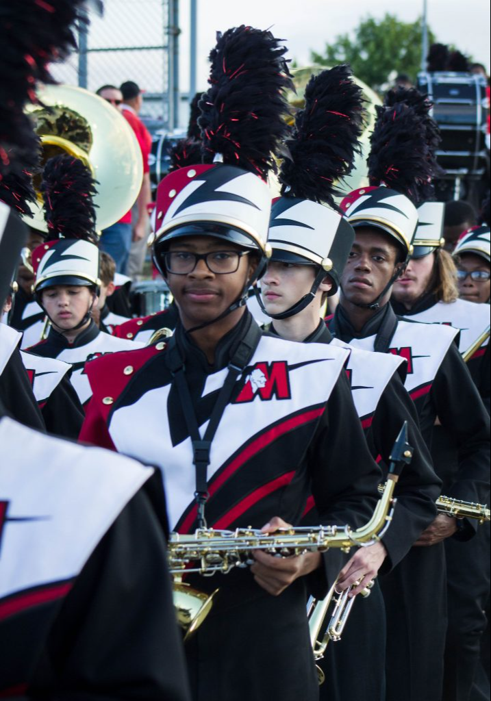 Marching band students lined up on the school field