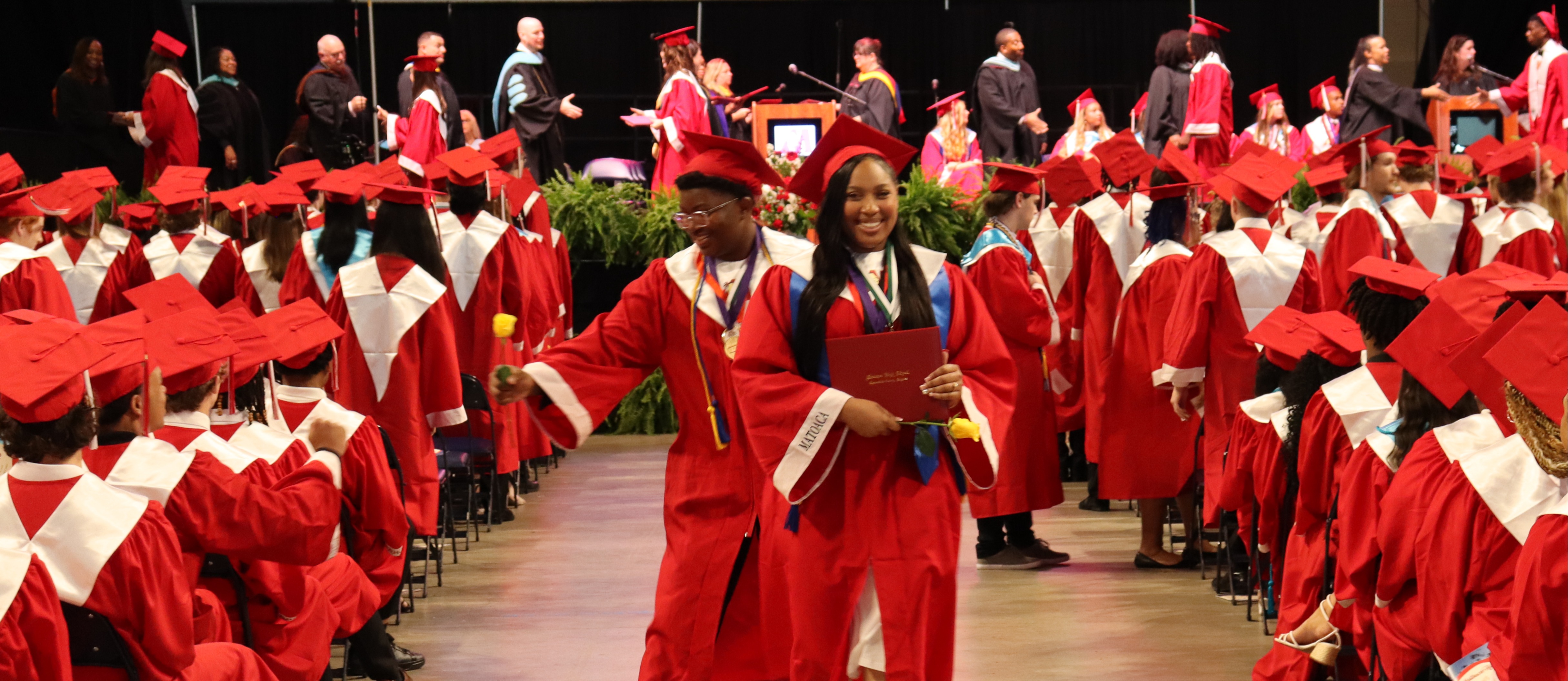 grads smile for a photo