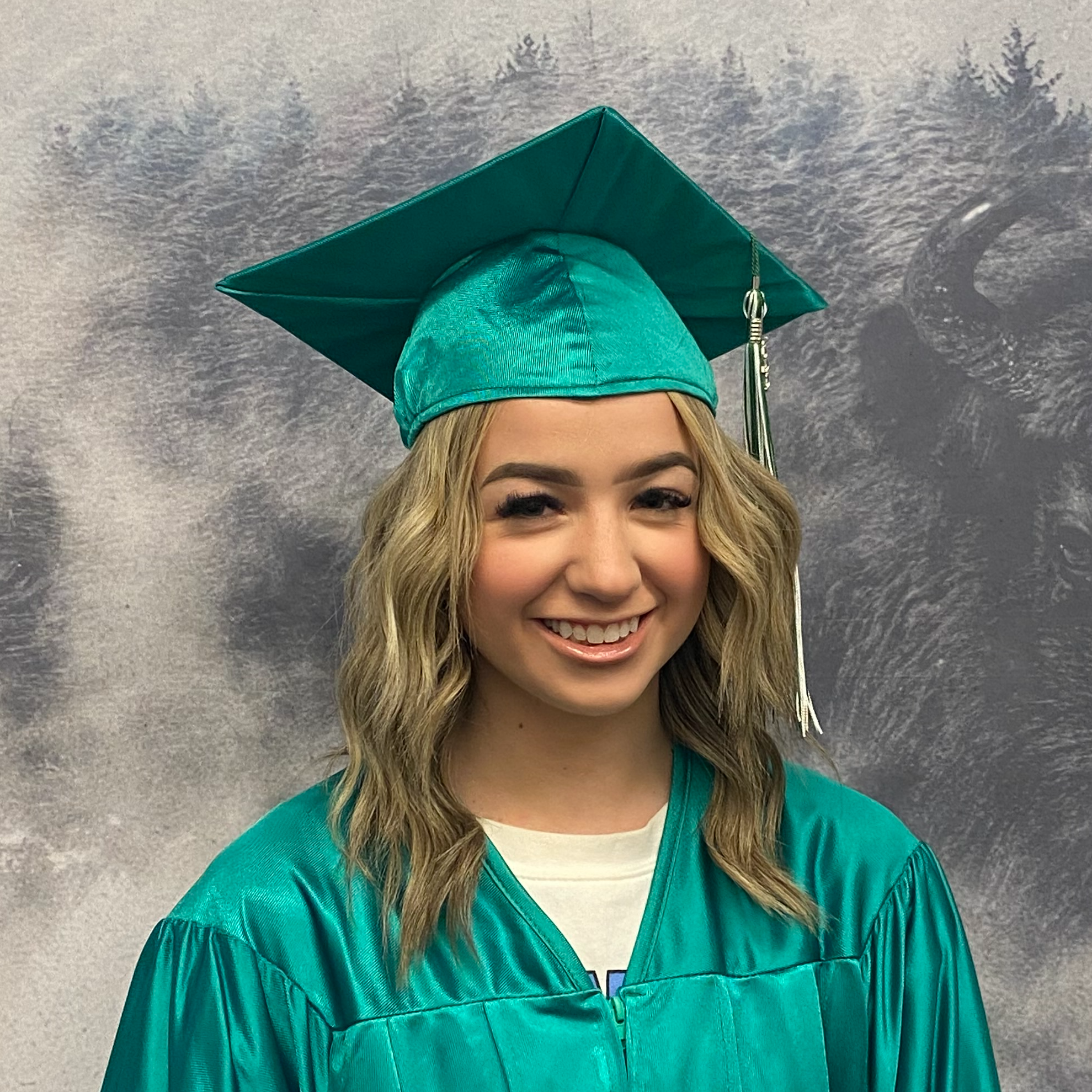 Kylee Labrum in green graduation robes and cap
