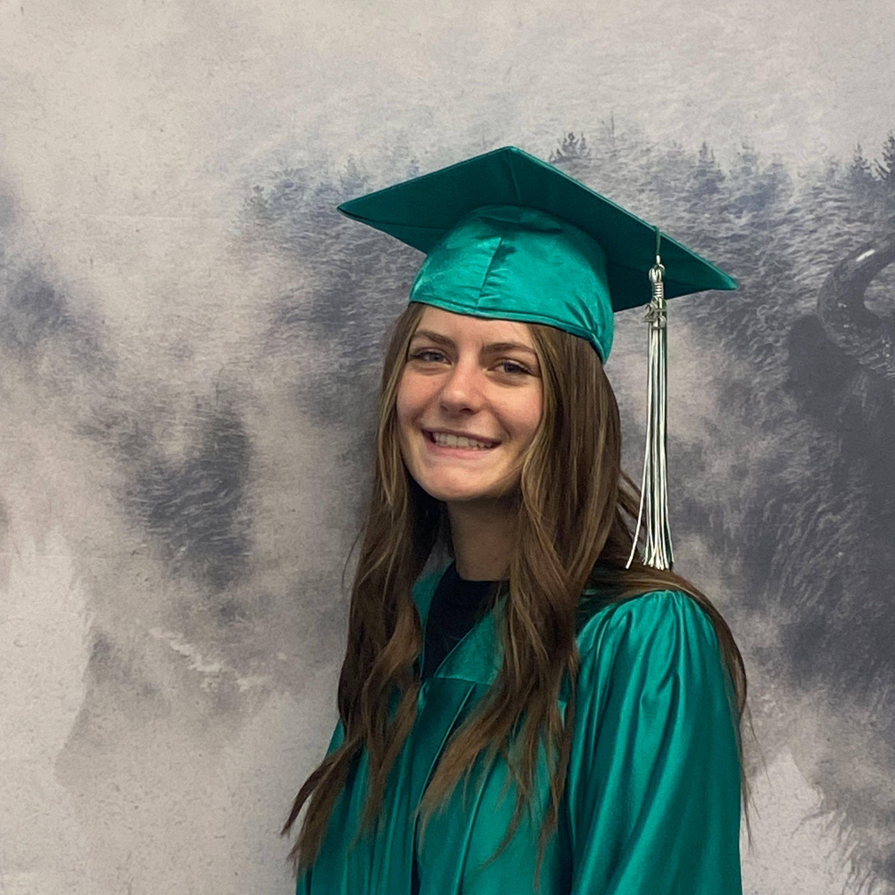 Melania Migliori in green graduation robes and cap