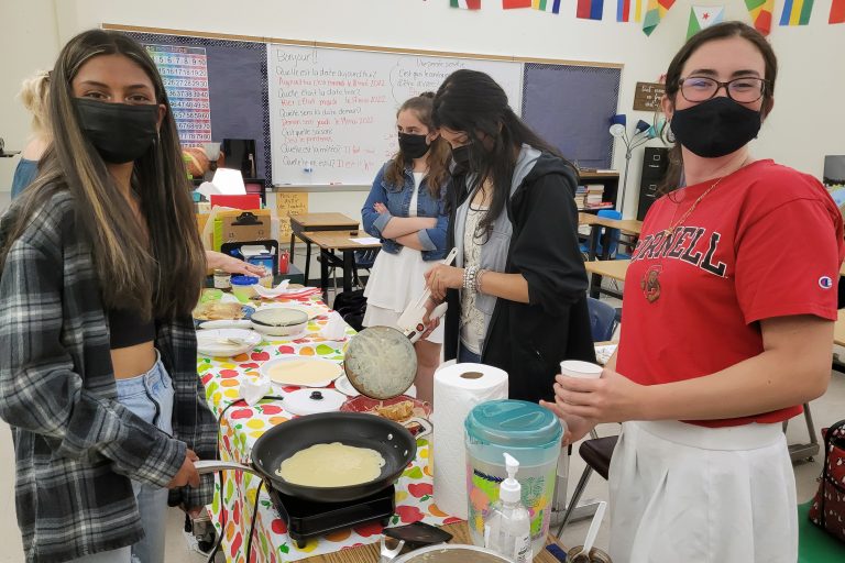 Students making crêpes in class